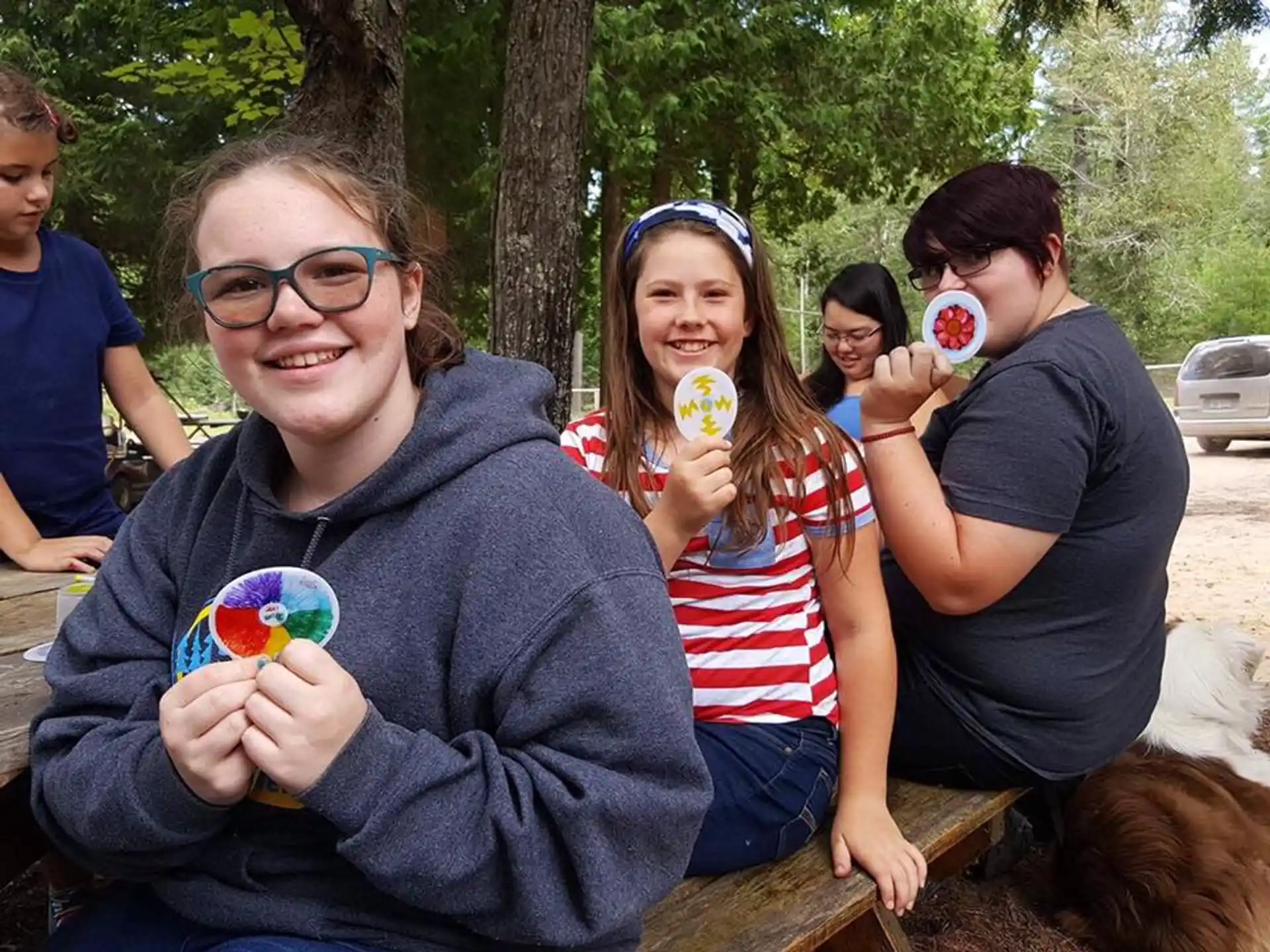 a group of people holding cupcakes