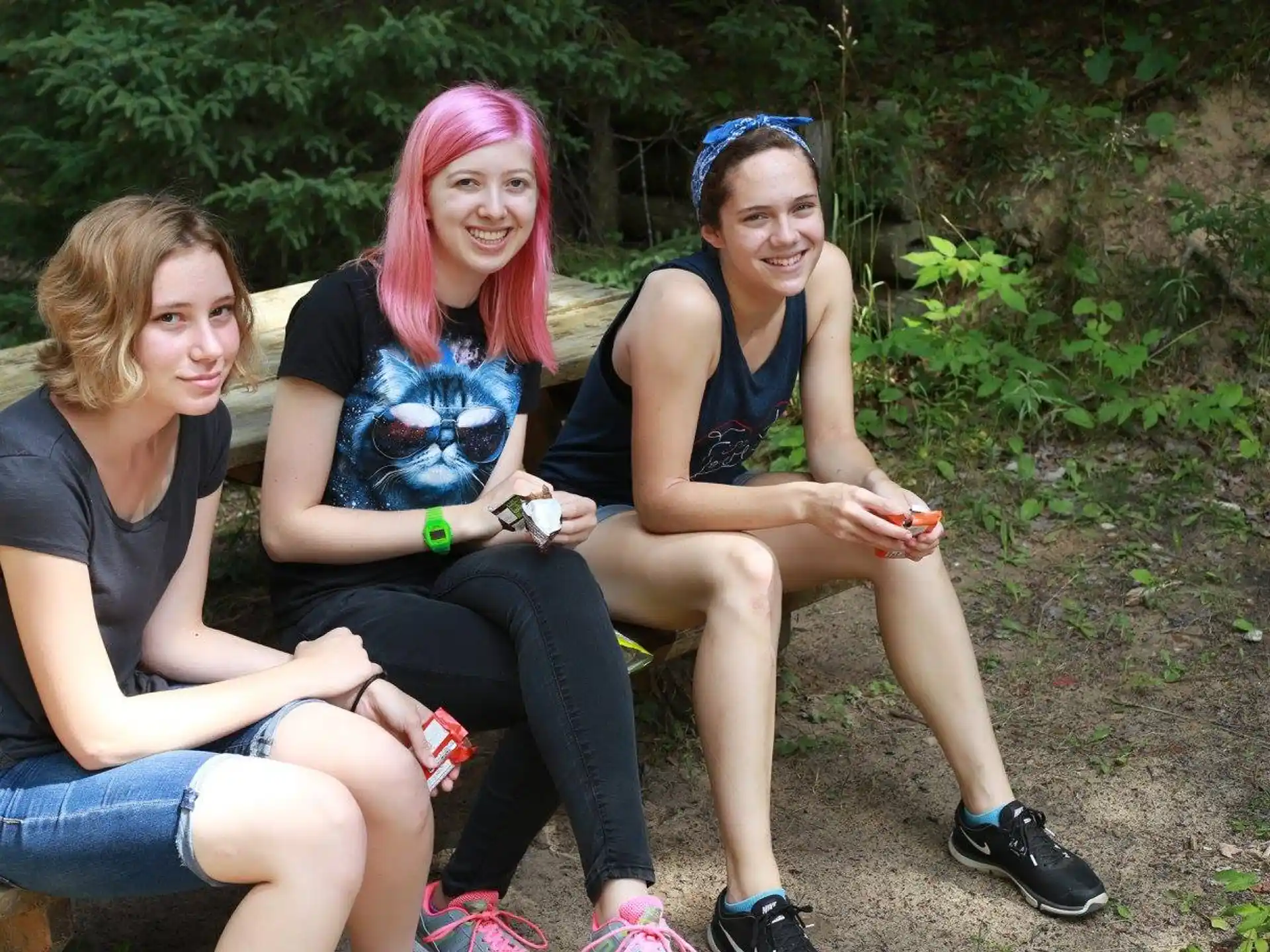 a group of women sitting on a bench