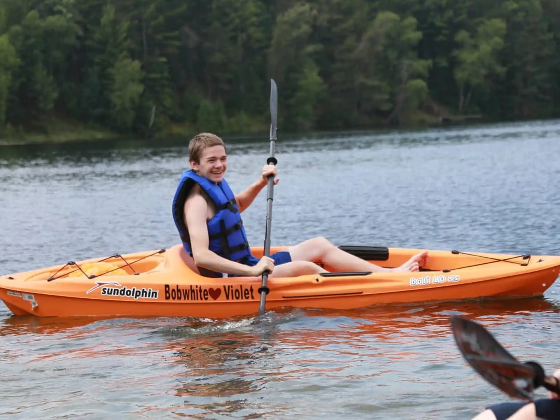 a person in a kayak holding a fishing pole