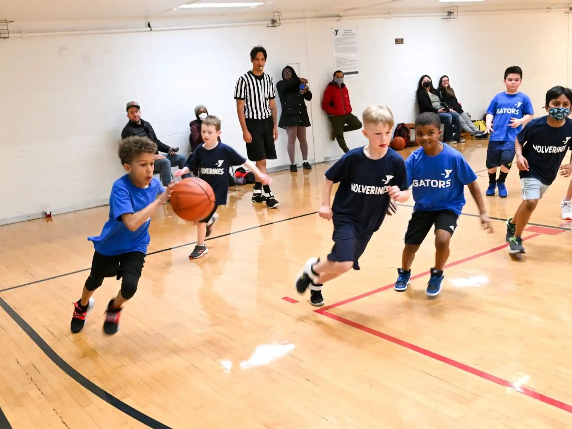 a group of kids playing basketball
