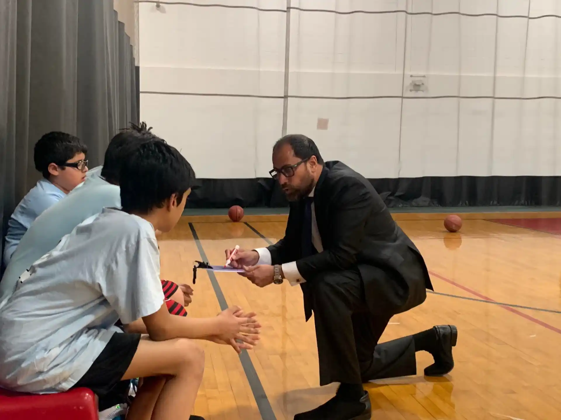 a person in a suit playing a game with other men
