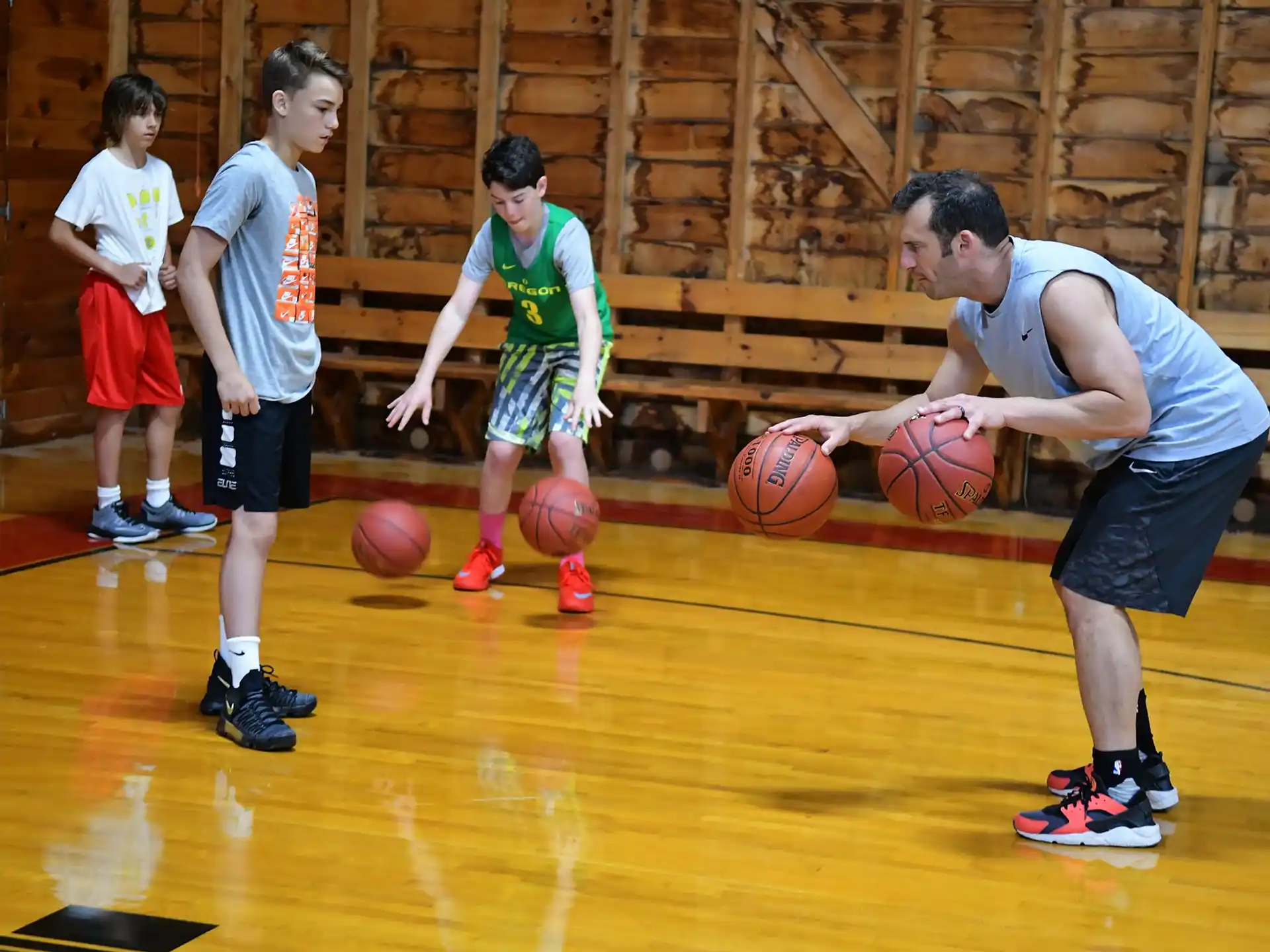 a group of kids playing basketball