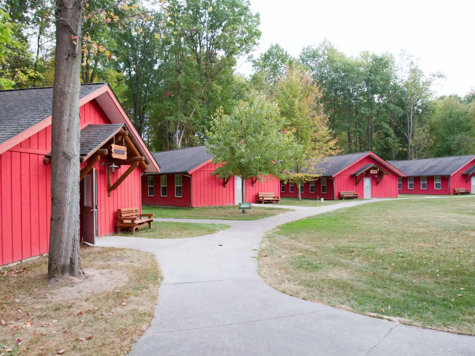 a path leading to a row of red buildings