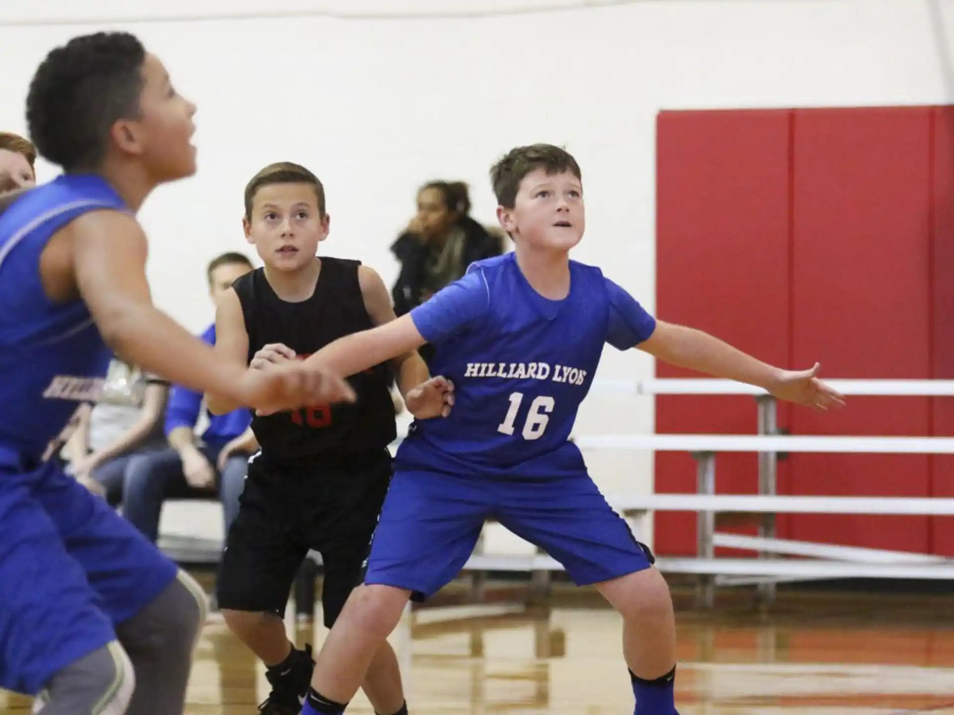 a group of people playing basketball