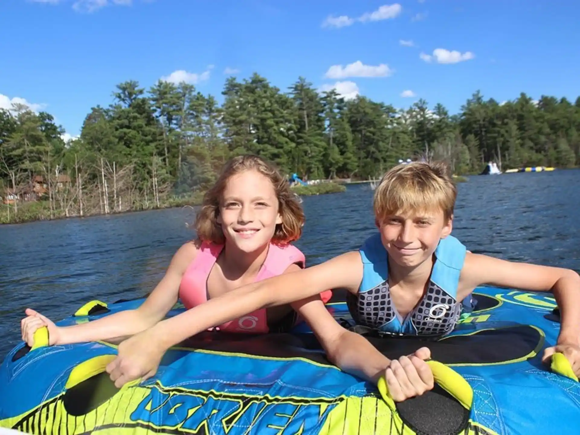 a boy and girl on a raft
