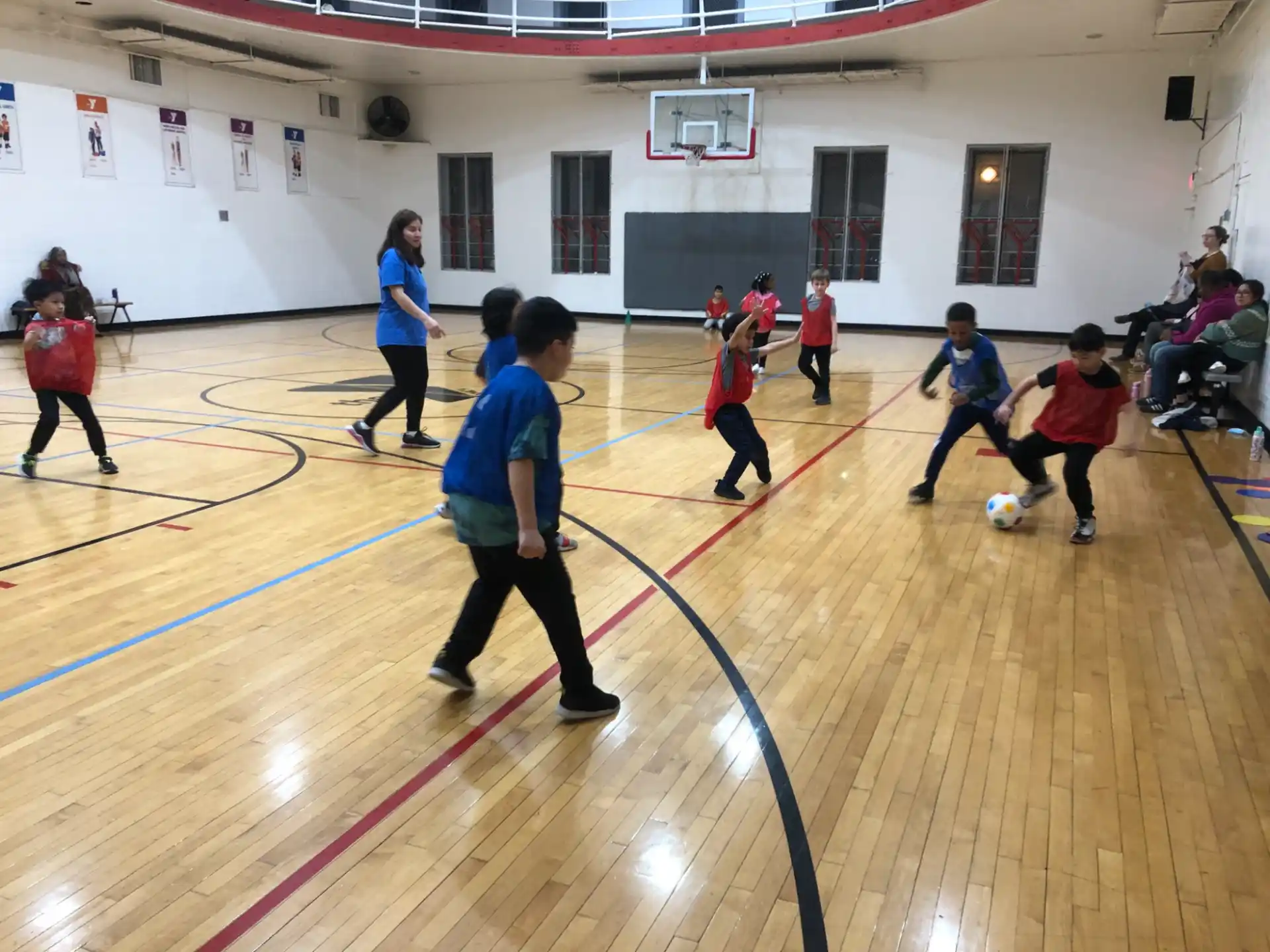 a group of people playing basketball