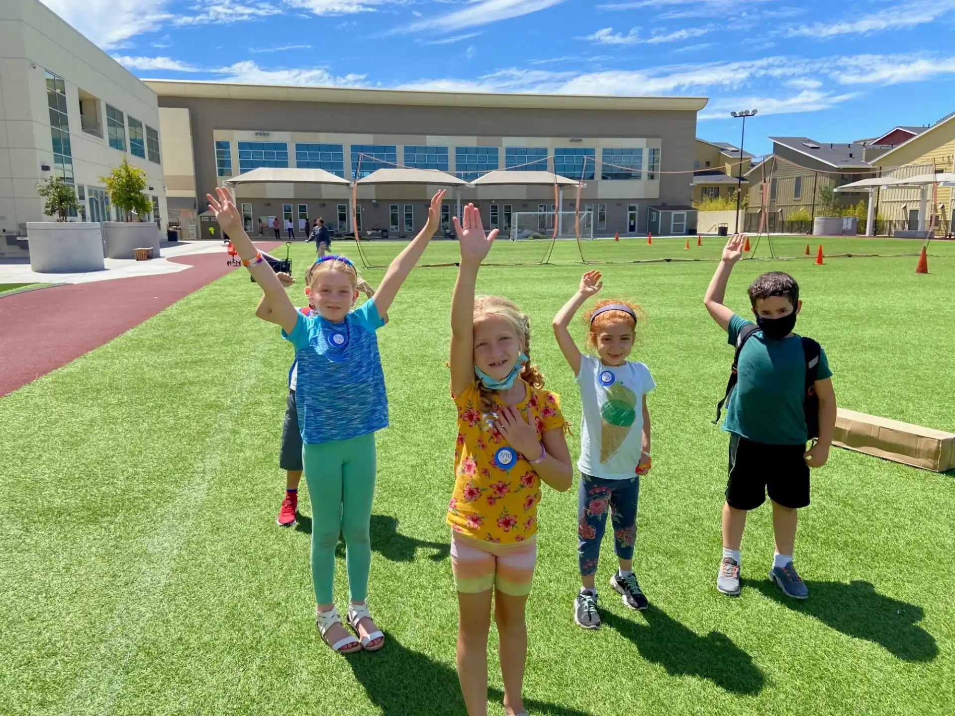 a group of children posing for a photo in front of a building