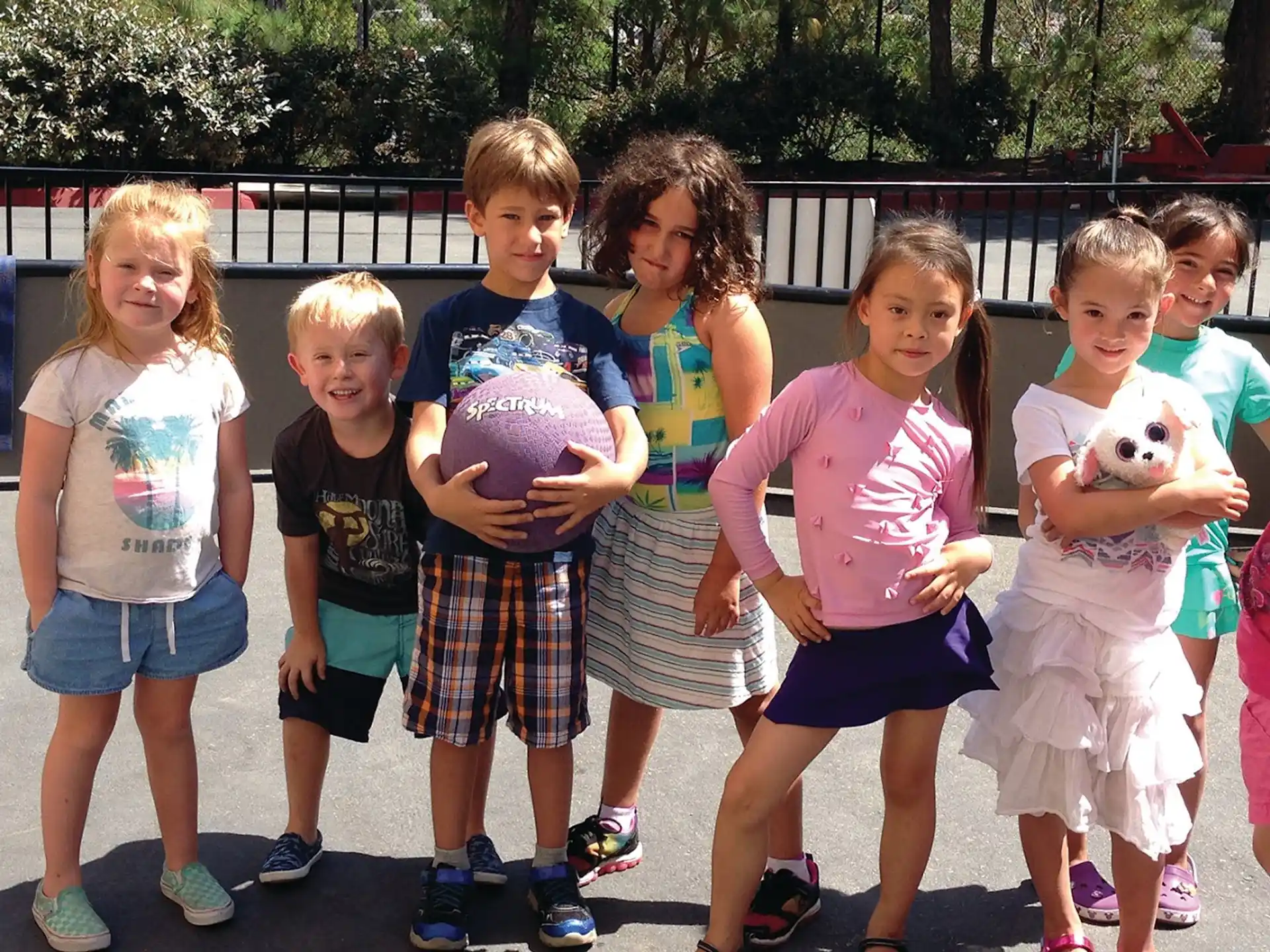 a group of children holding a stuffed animal