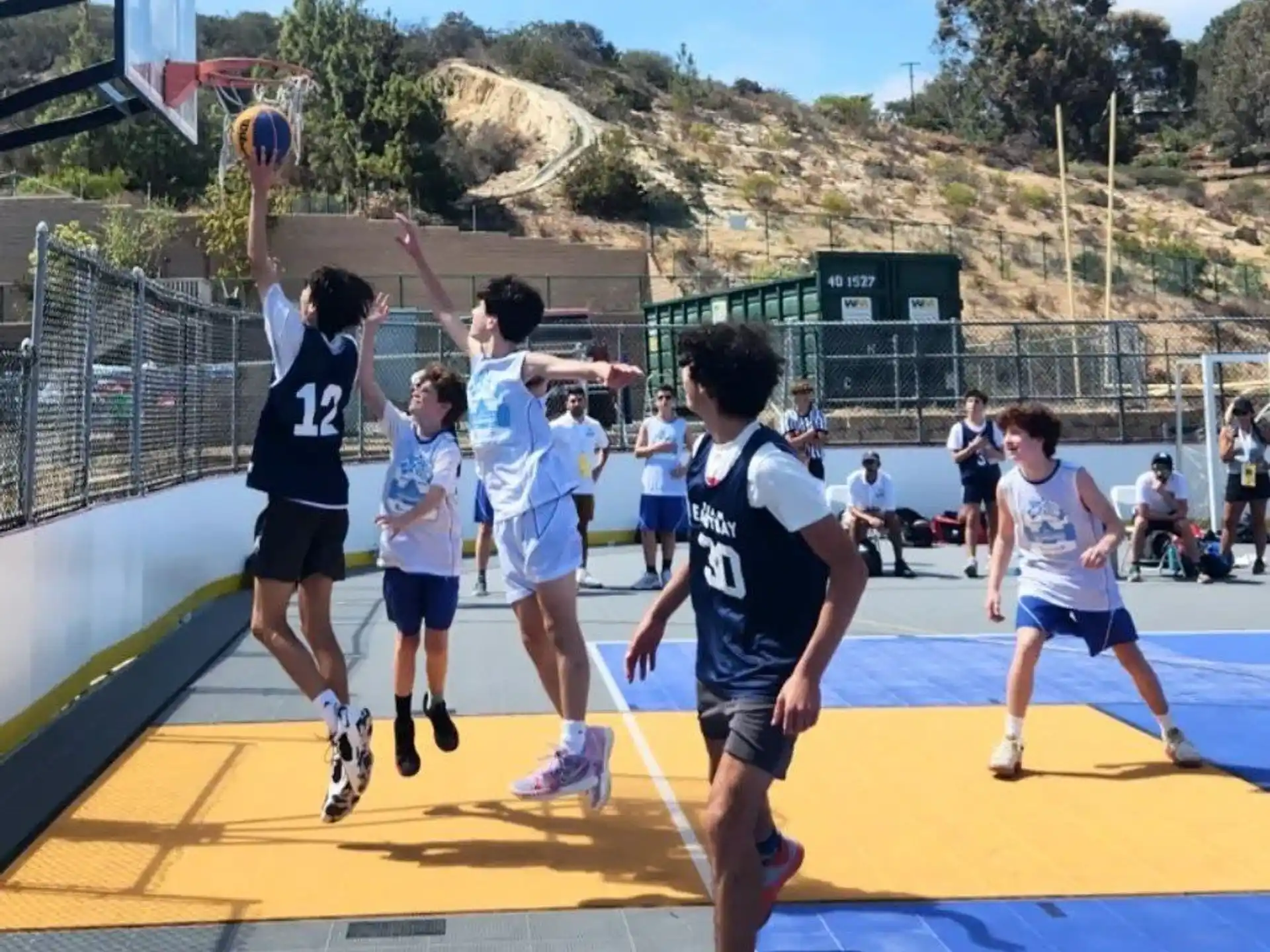 a group of people playing basketball