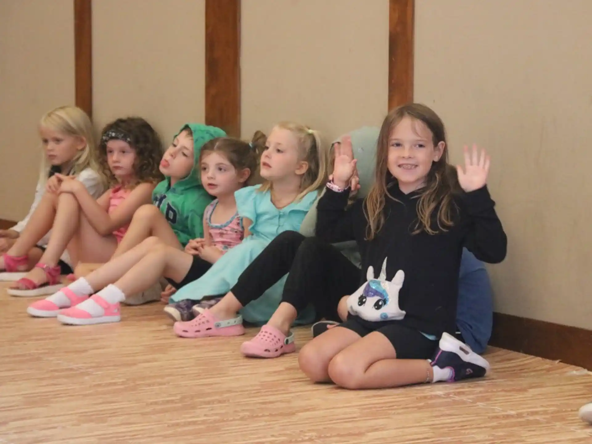 a group of children sitting on the floor