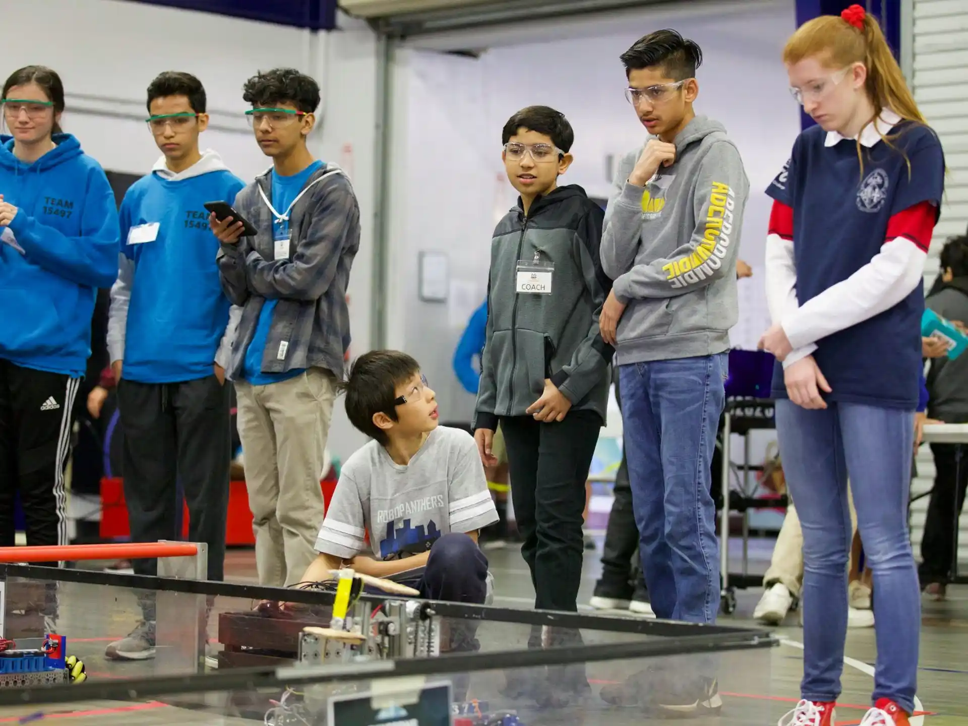 a group of people standing around a table