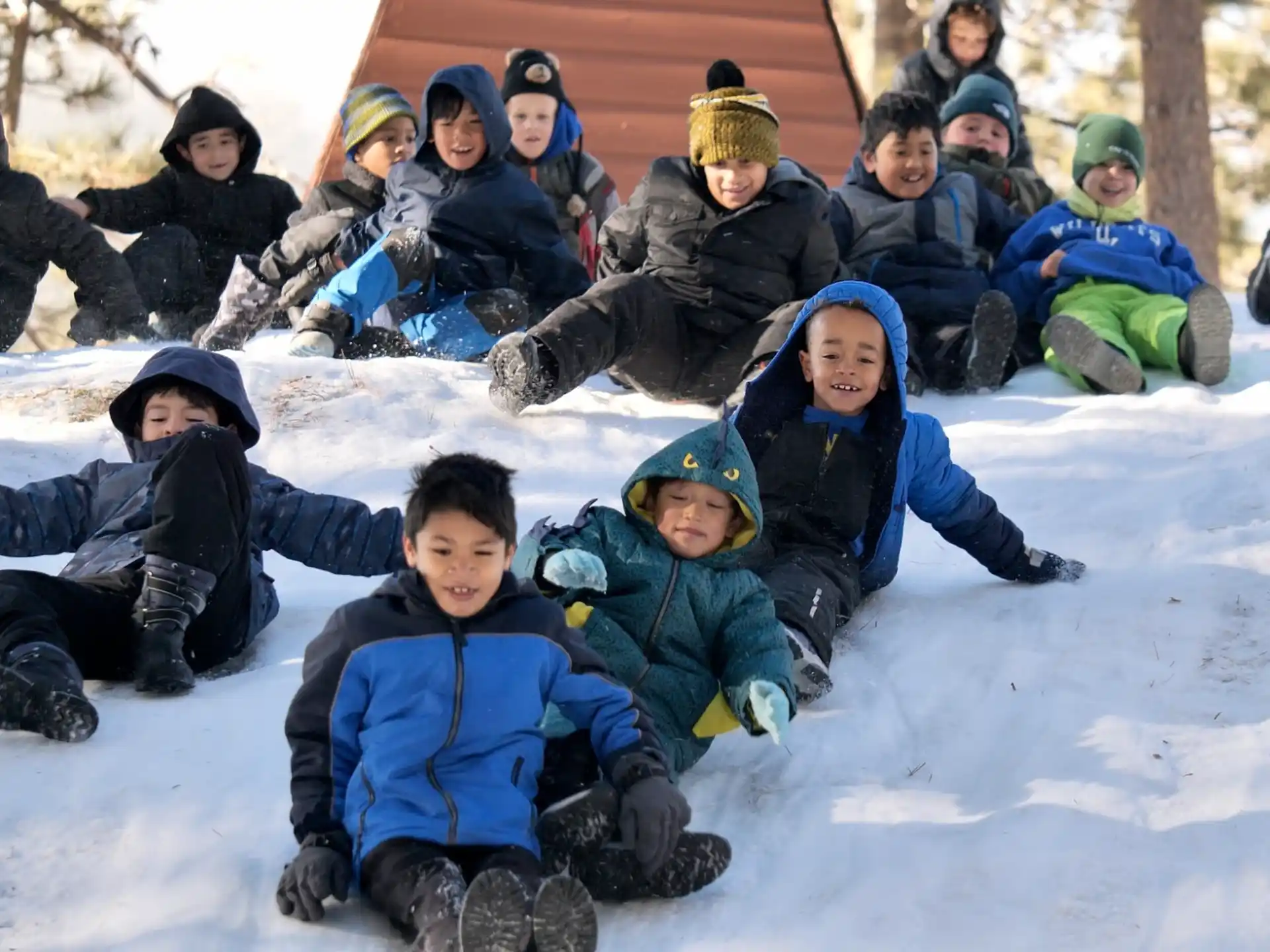 a group of people sitting in the snow