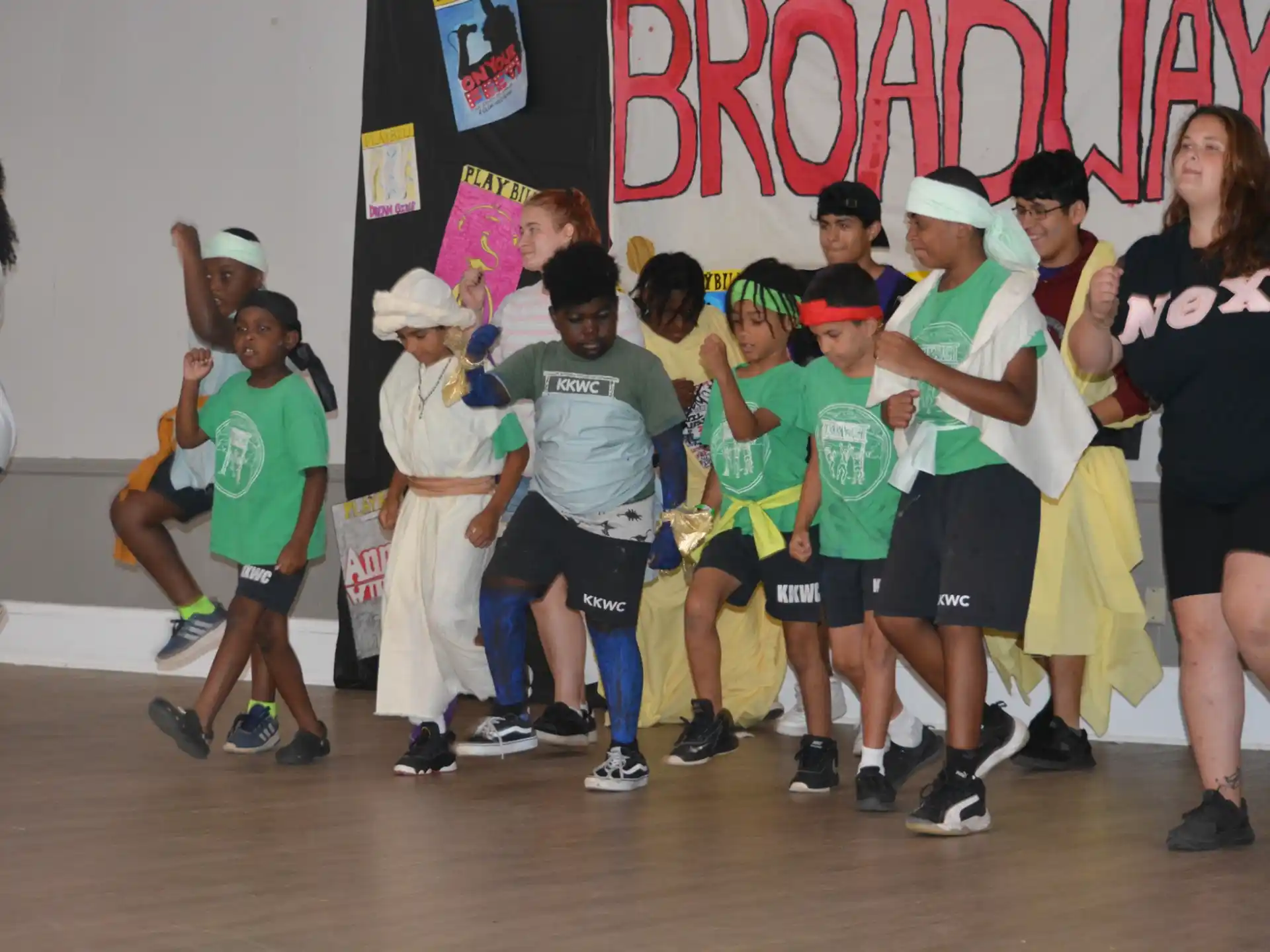 a group of children in matching green and white shirts