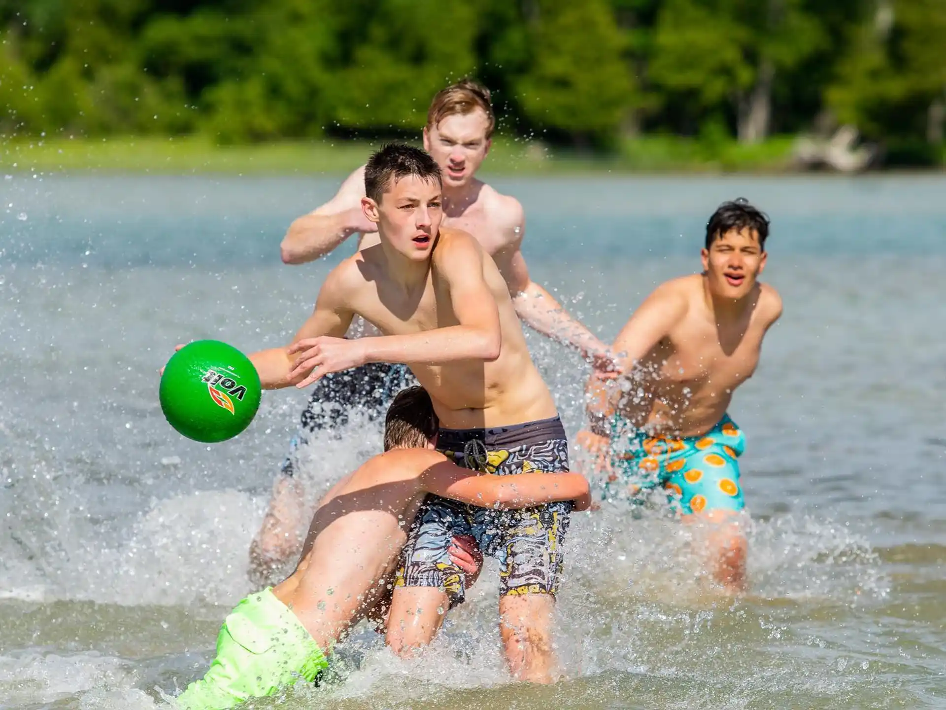 a group of men playing in the water