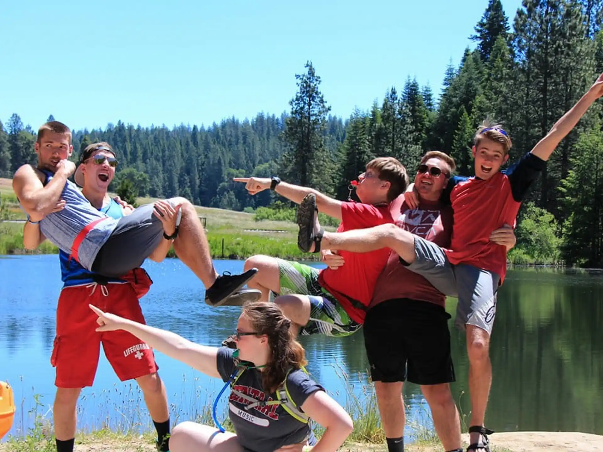 a group of people jumping into the water