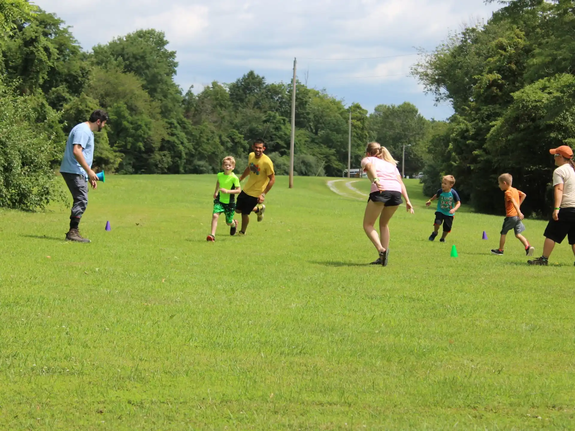 a group of people playing with a ball in a field