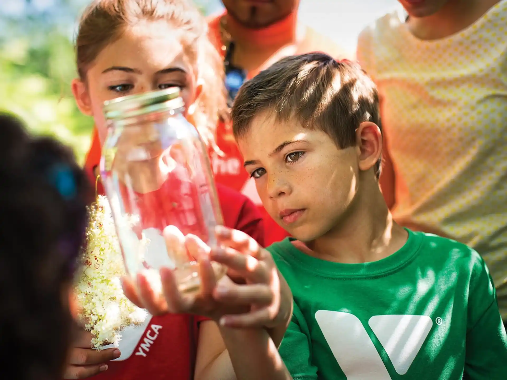 a young boy holding a bottle of water