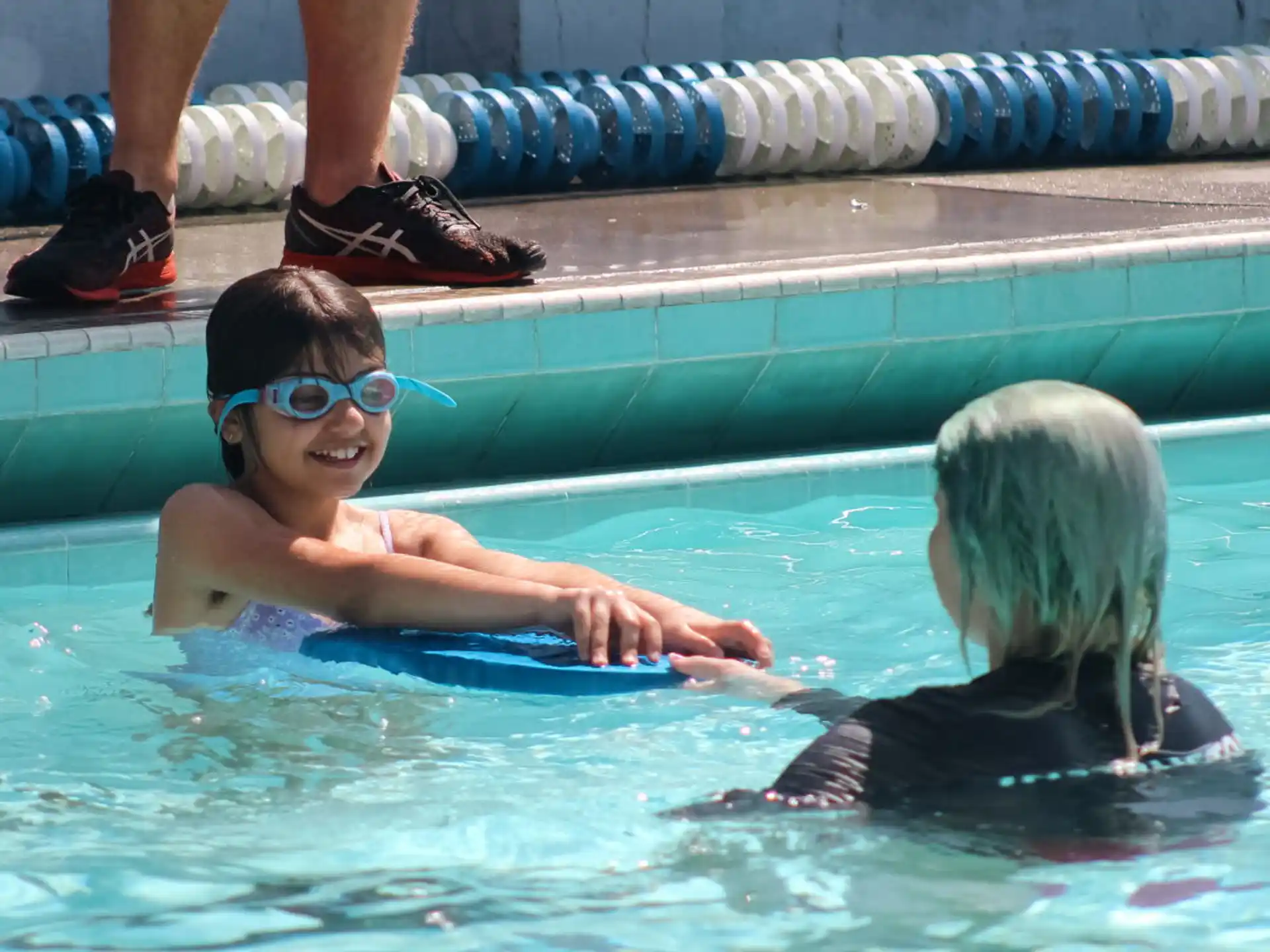 a boy and a girl in a pool