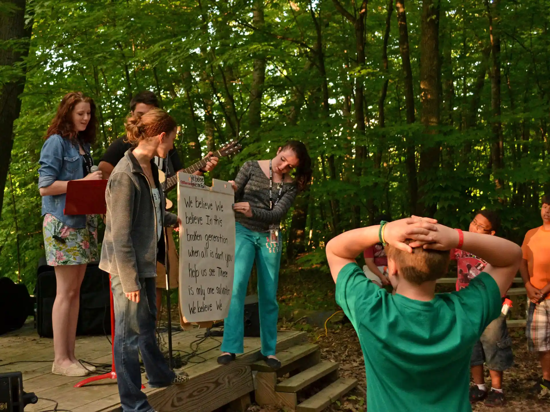 a group of people standing in a forest