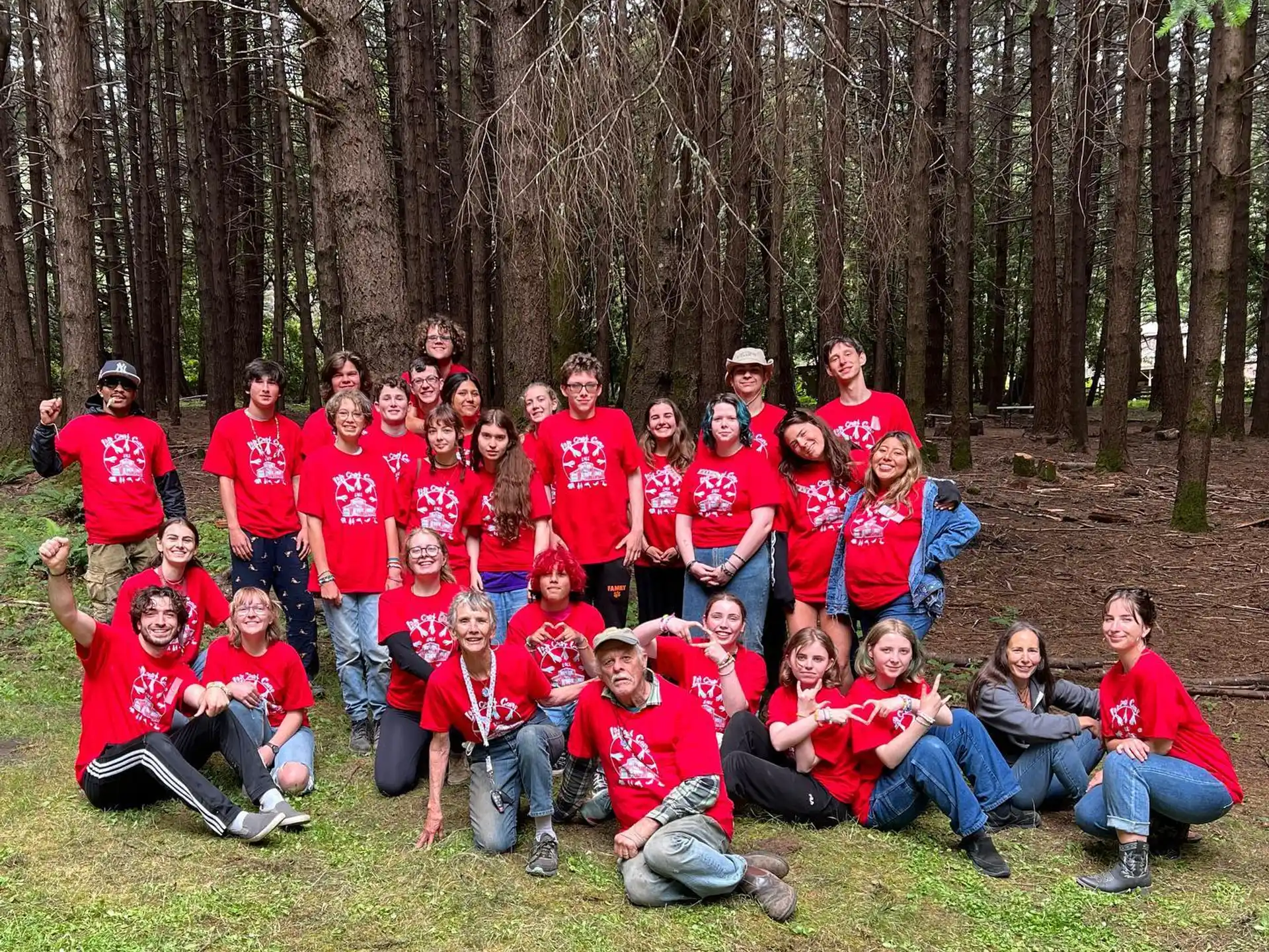 a group of people in red shirts posing for a photo
