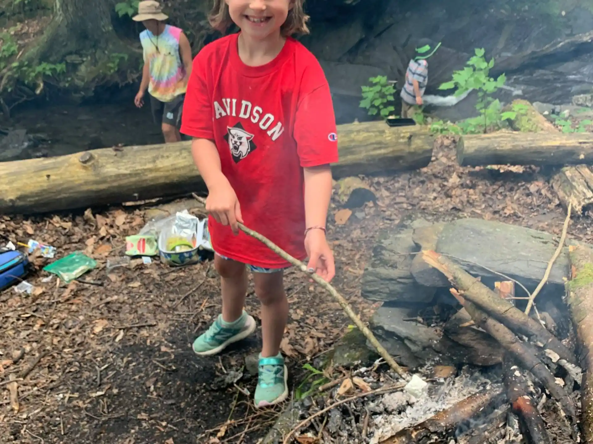 a girl standing on a log
