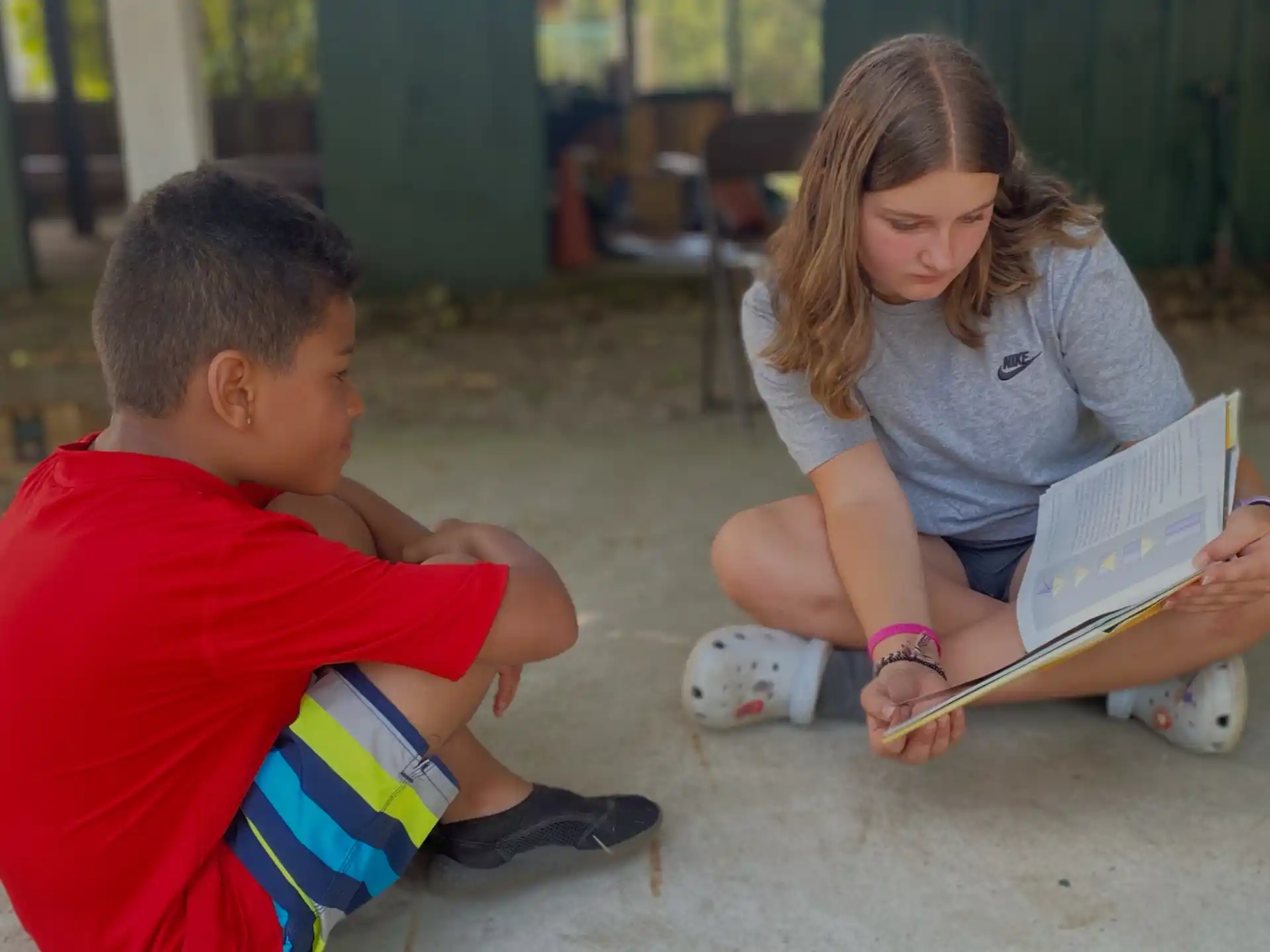 a person and a boy reading a book