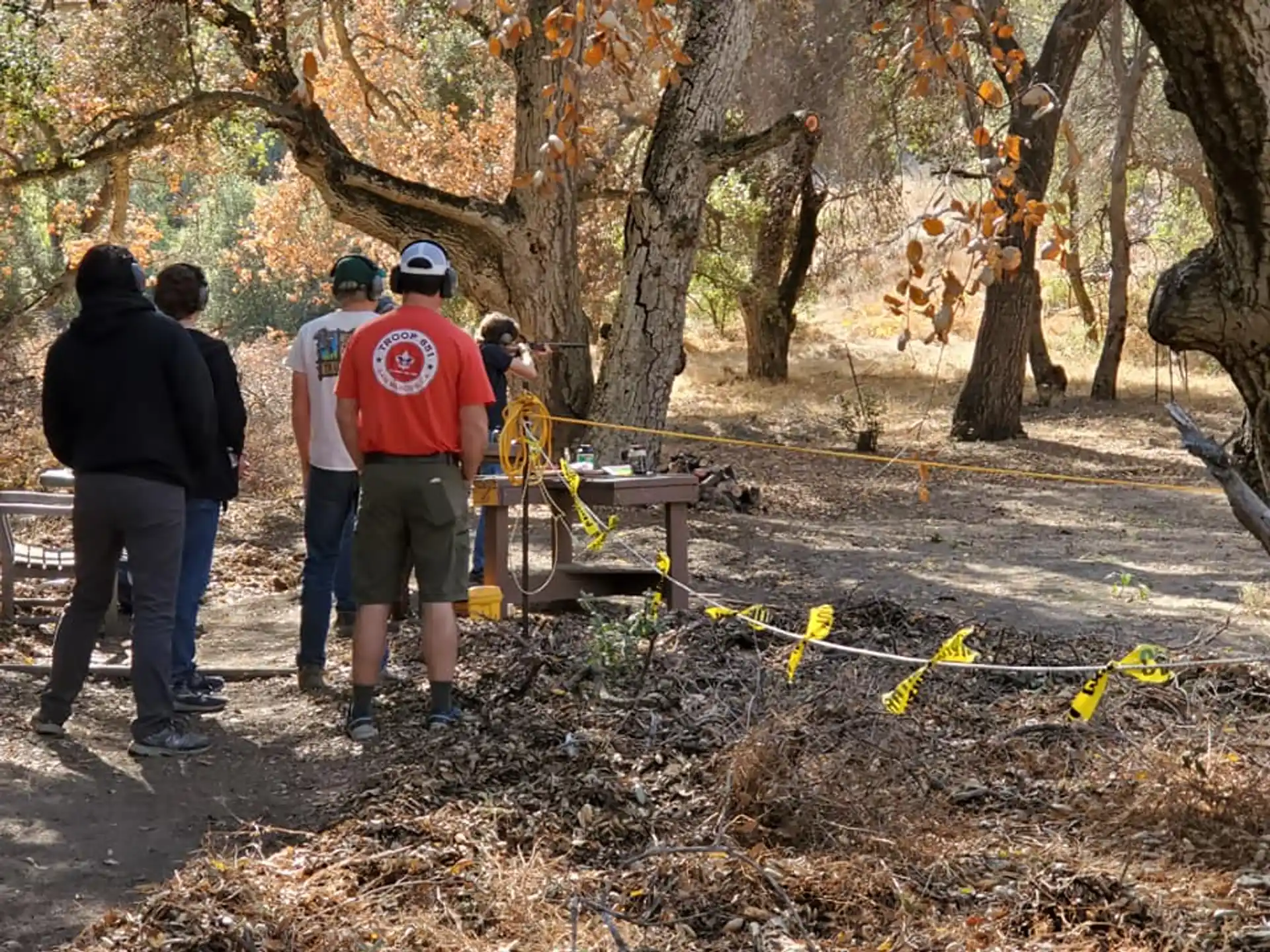 a group of people standing in a forest