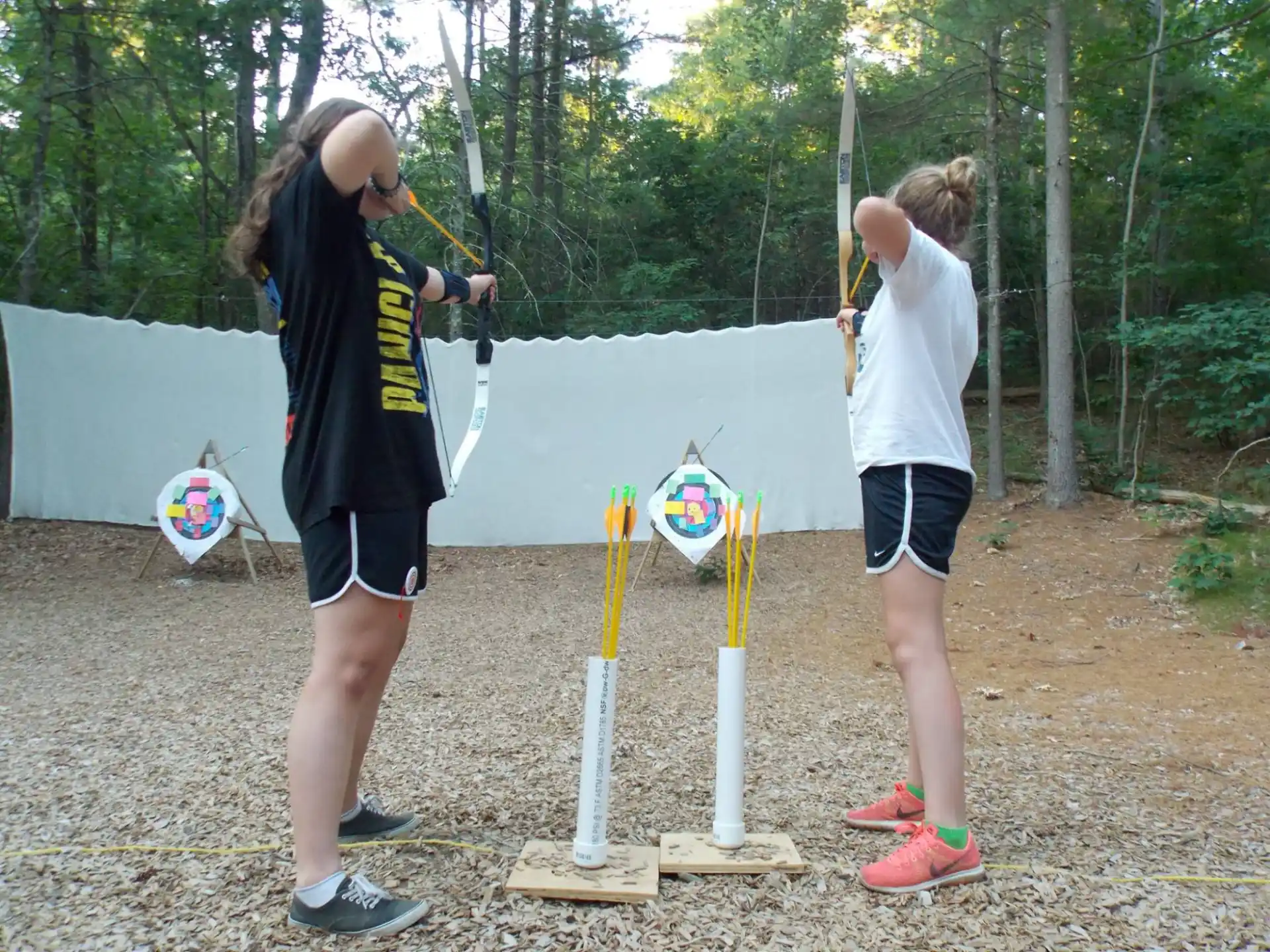 a couple of people holding bows and arrows