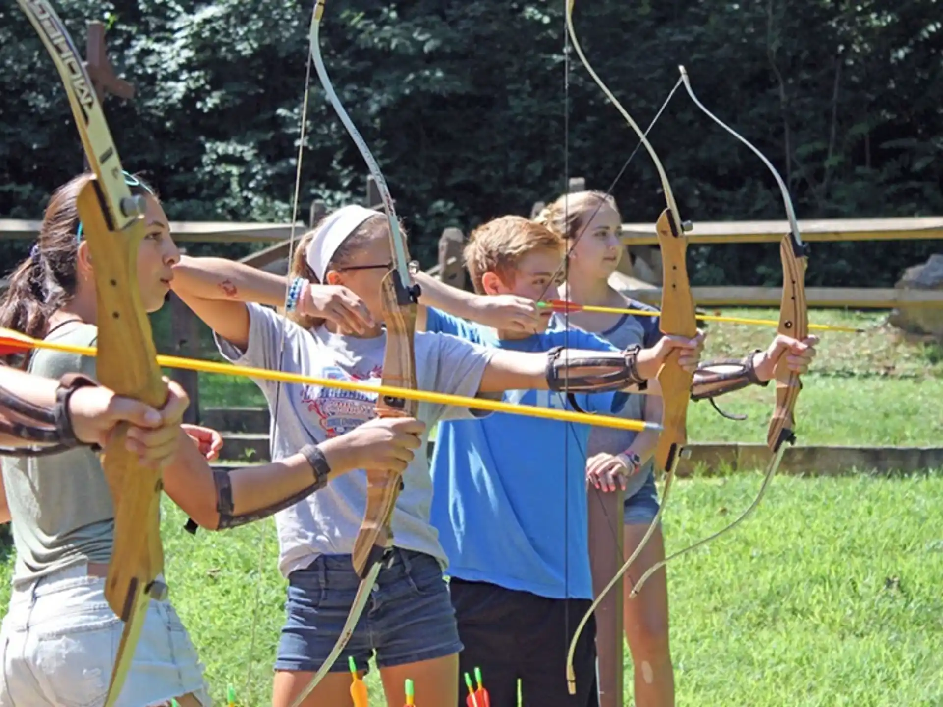 a group of people holding bows and arrows