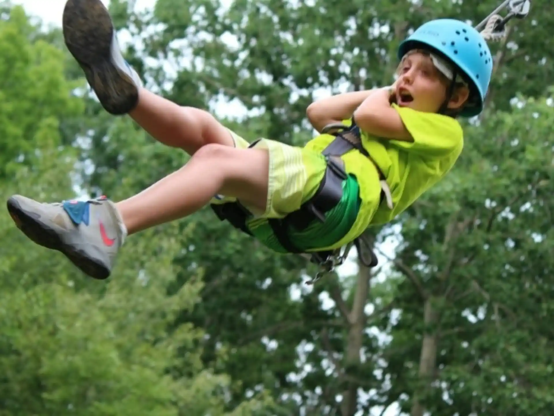 a boy wearing a helmet and jumping