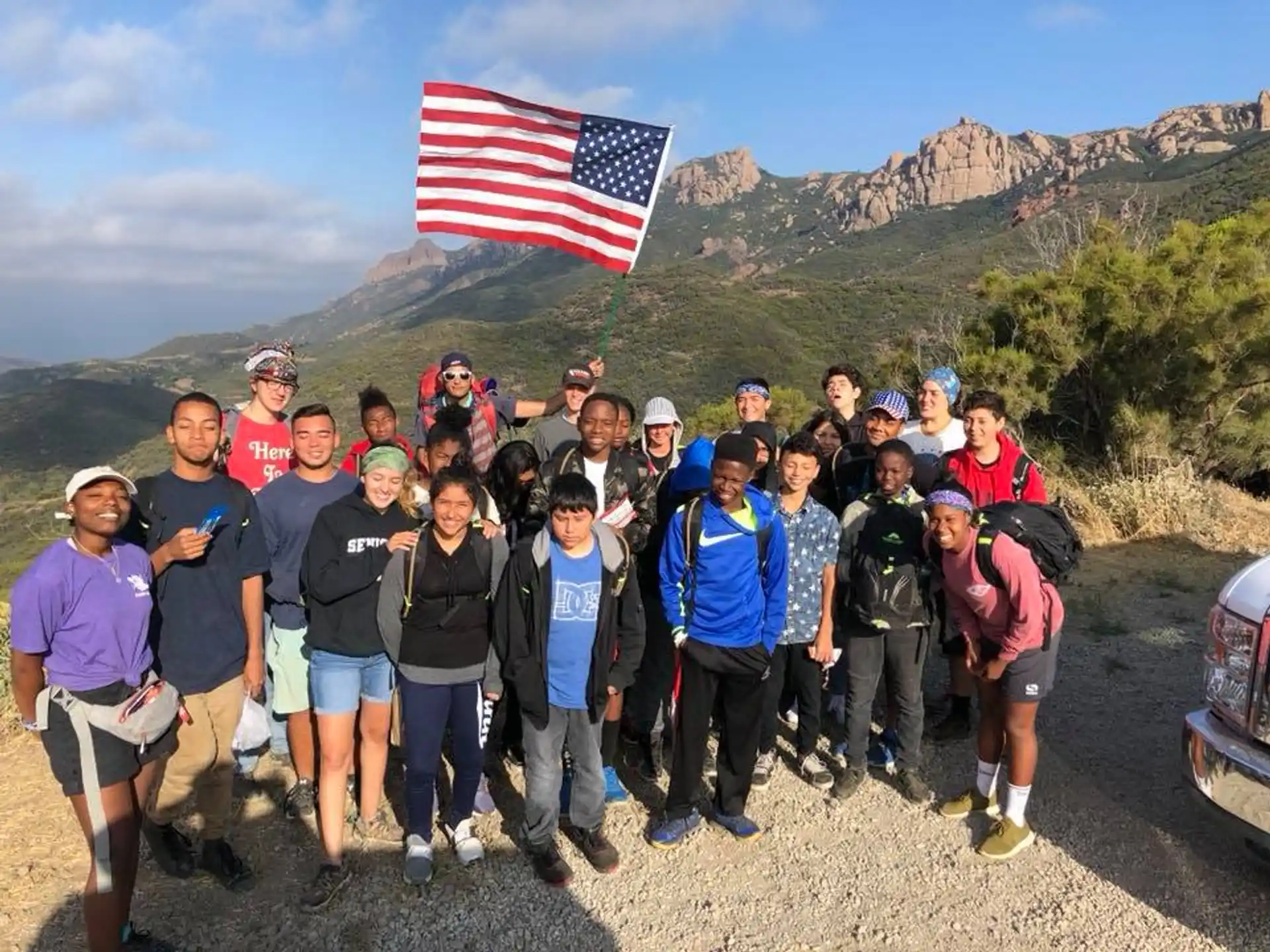 a group of people posing for a photo with a flag