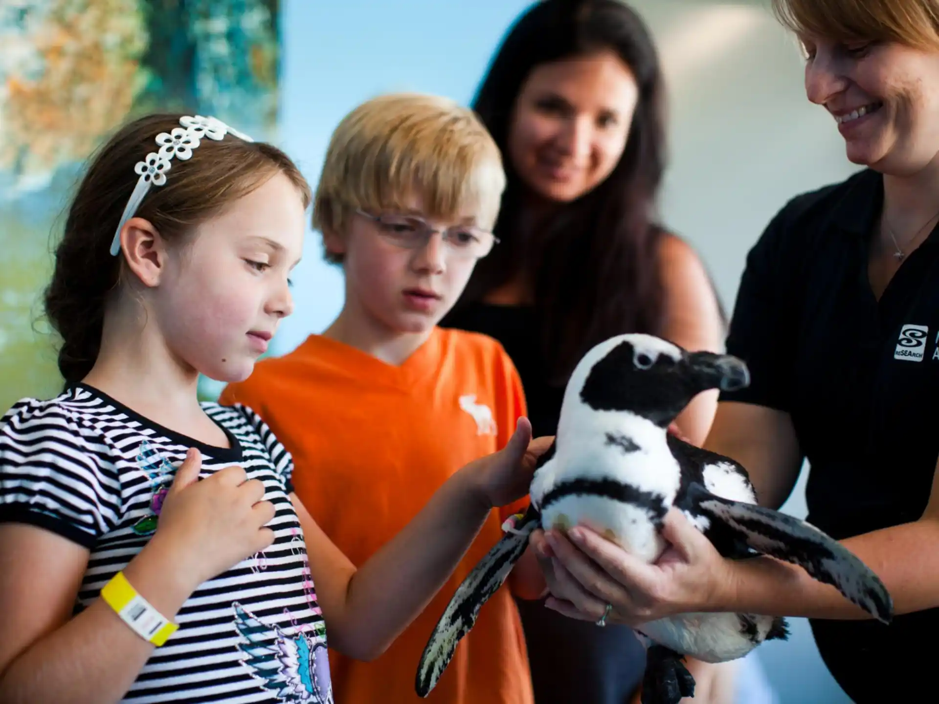 a group of people holding a stuffed animal