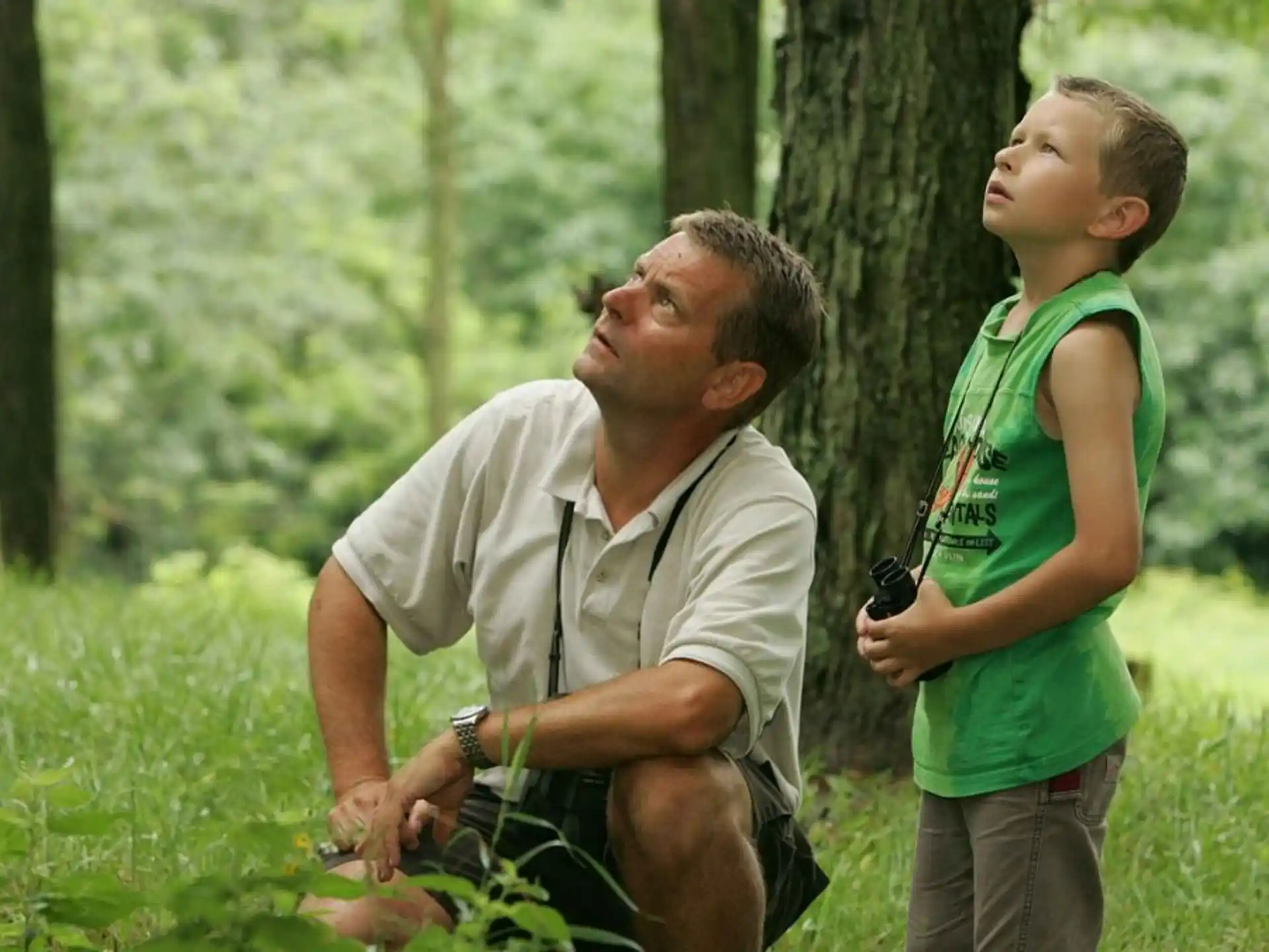 a man and a boy in the grass