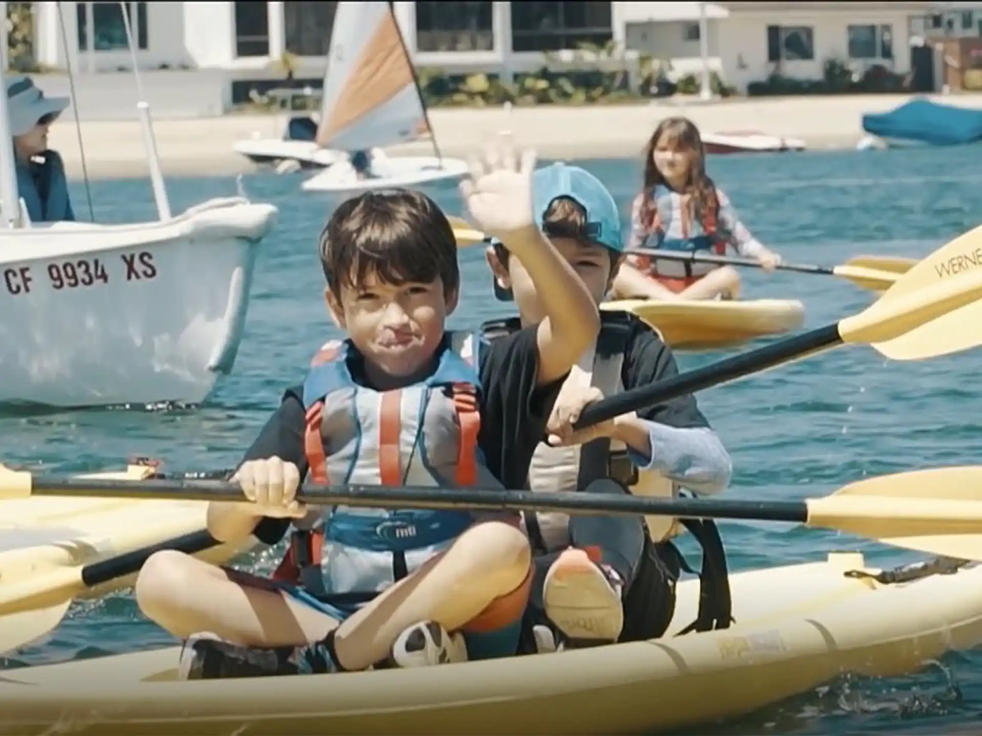 a group of people in a rowboat on the water