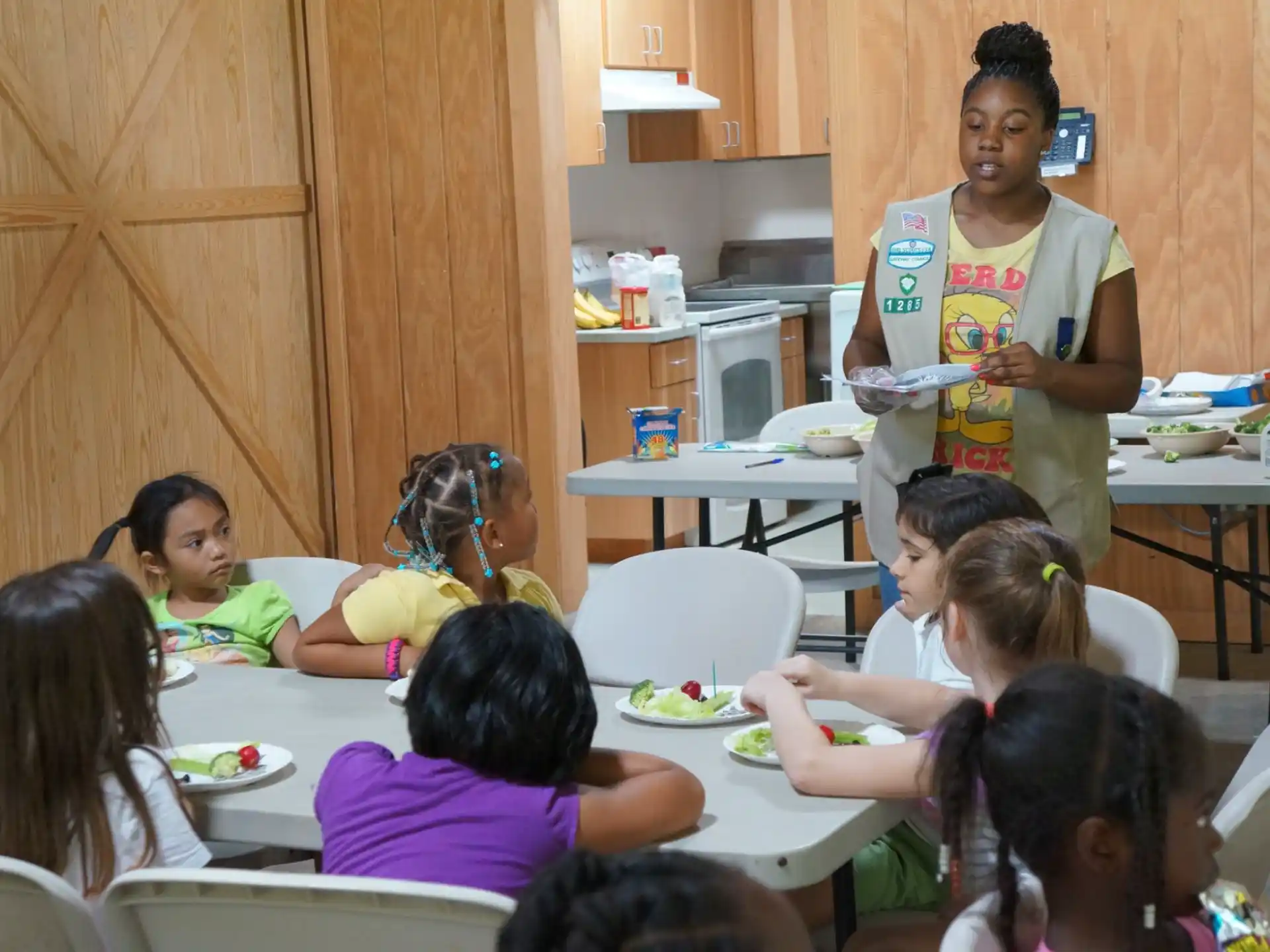a person serving a group of children