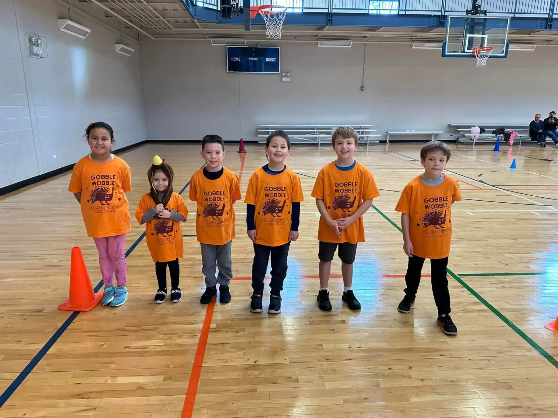 a group of kids wearing orange shirts