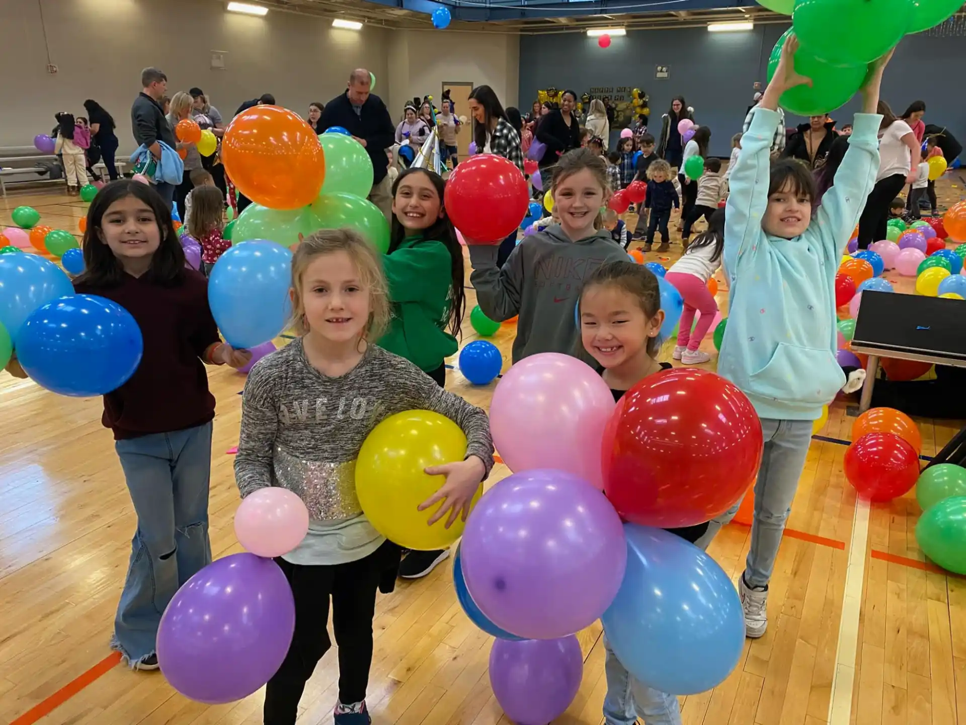 a group of people holding balloons