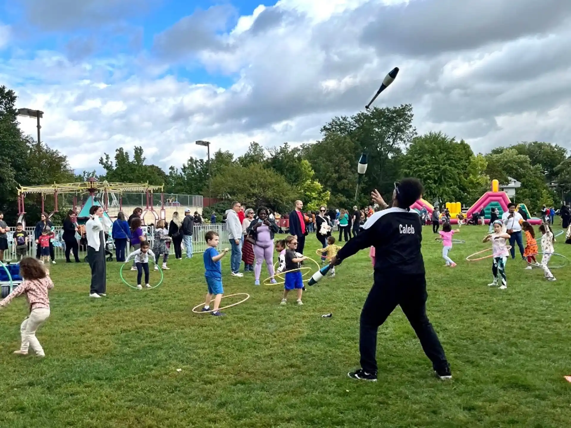 a person playing with a group of kids in a field