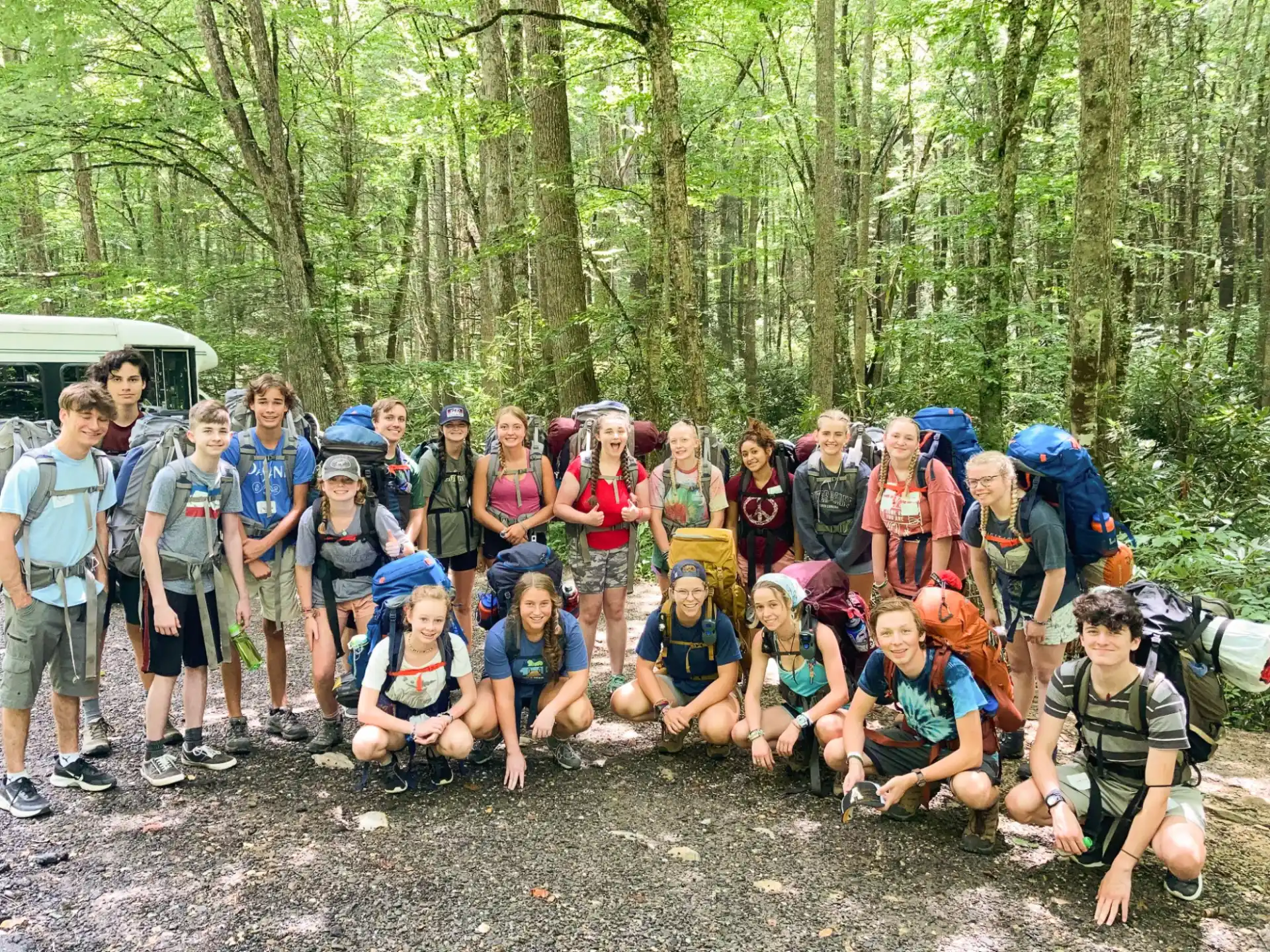 a group of people posing for a photo in the woods