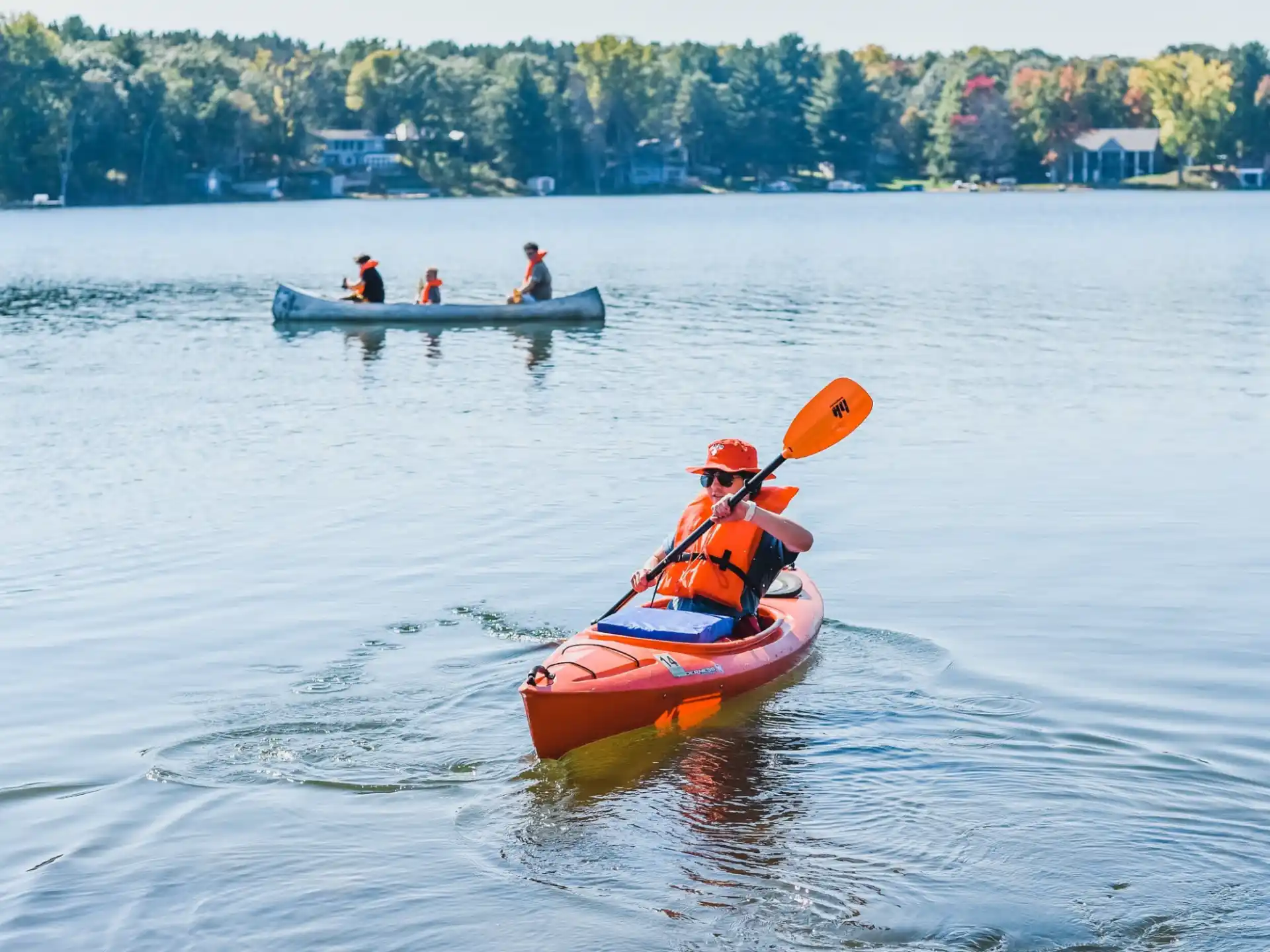 a group of people in kayaks on a lake