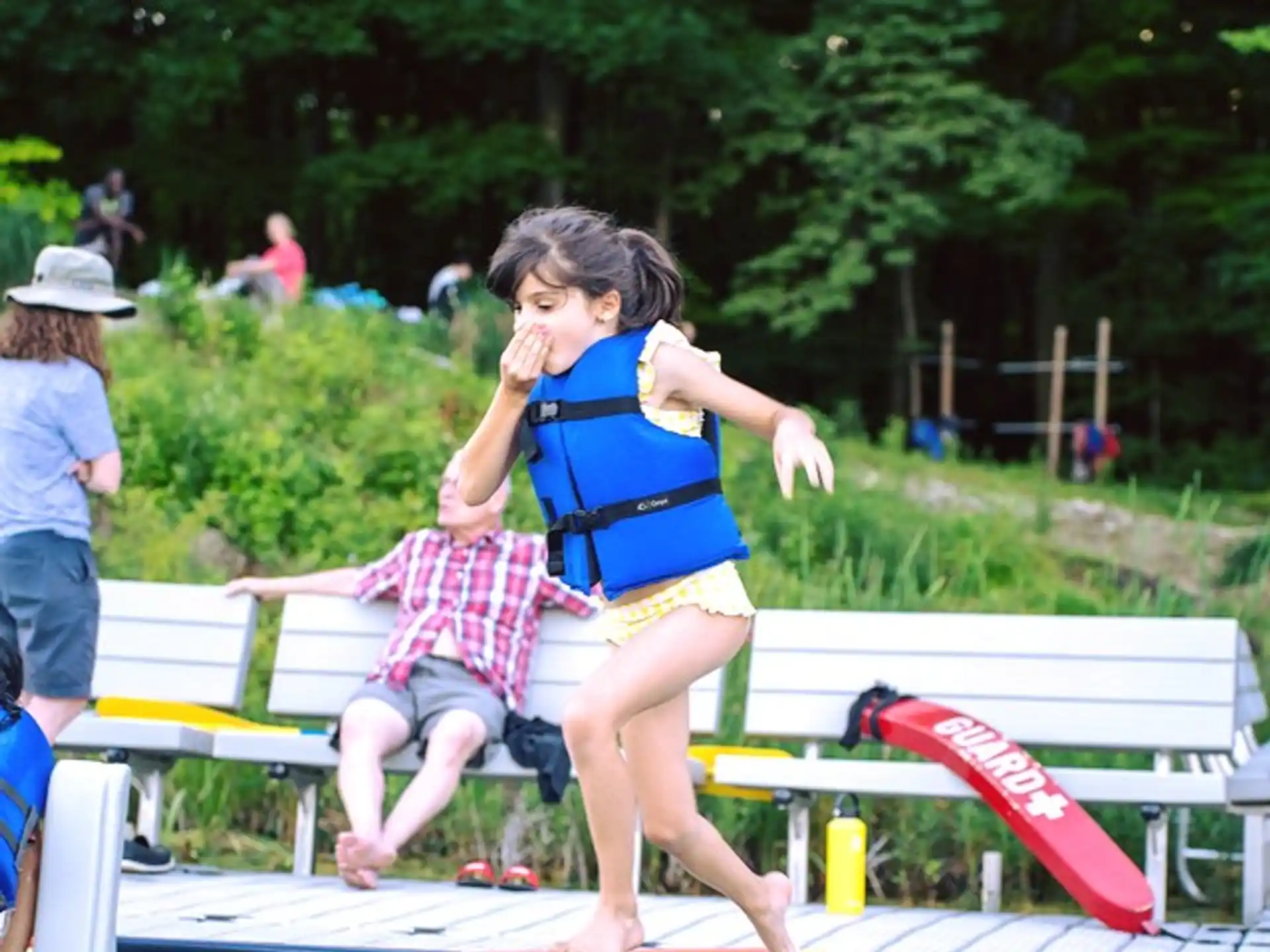 a girl jumping on a bench