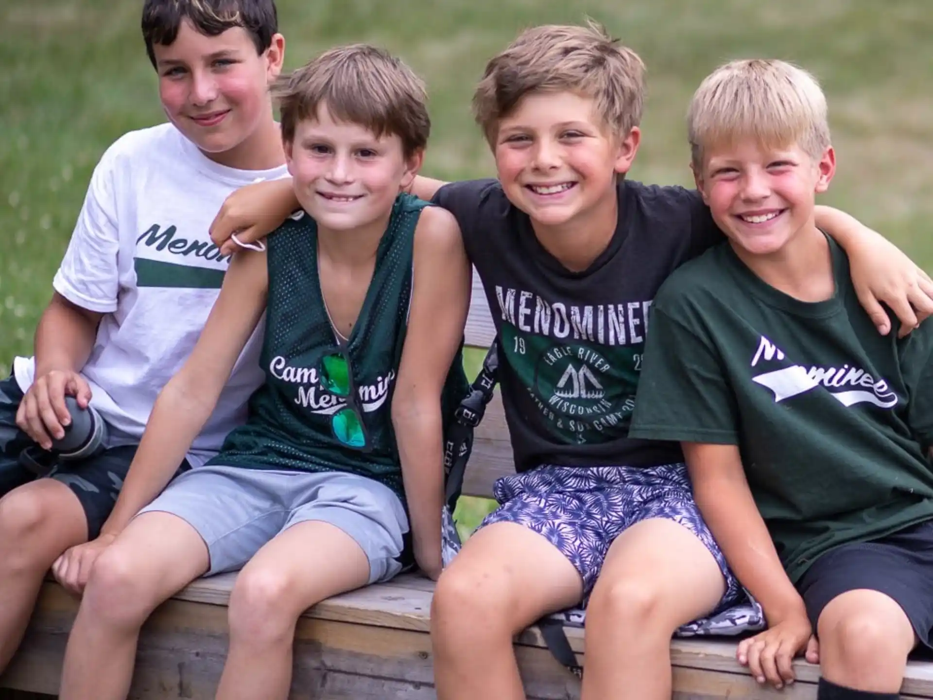 a group of boys sitting on a bench