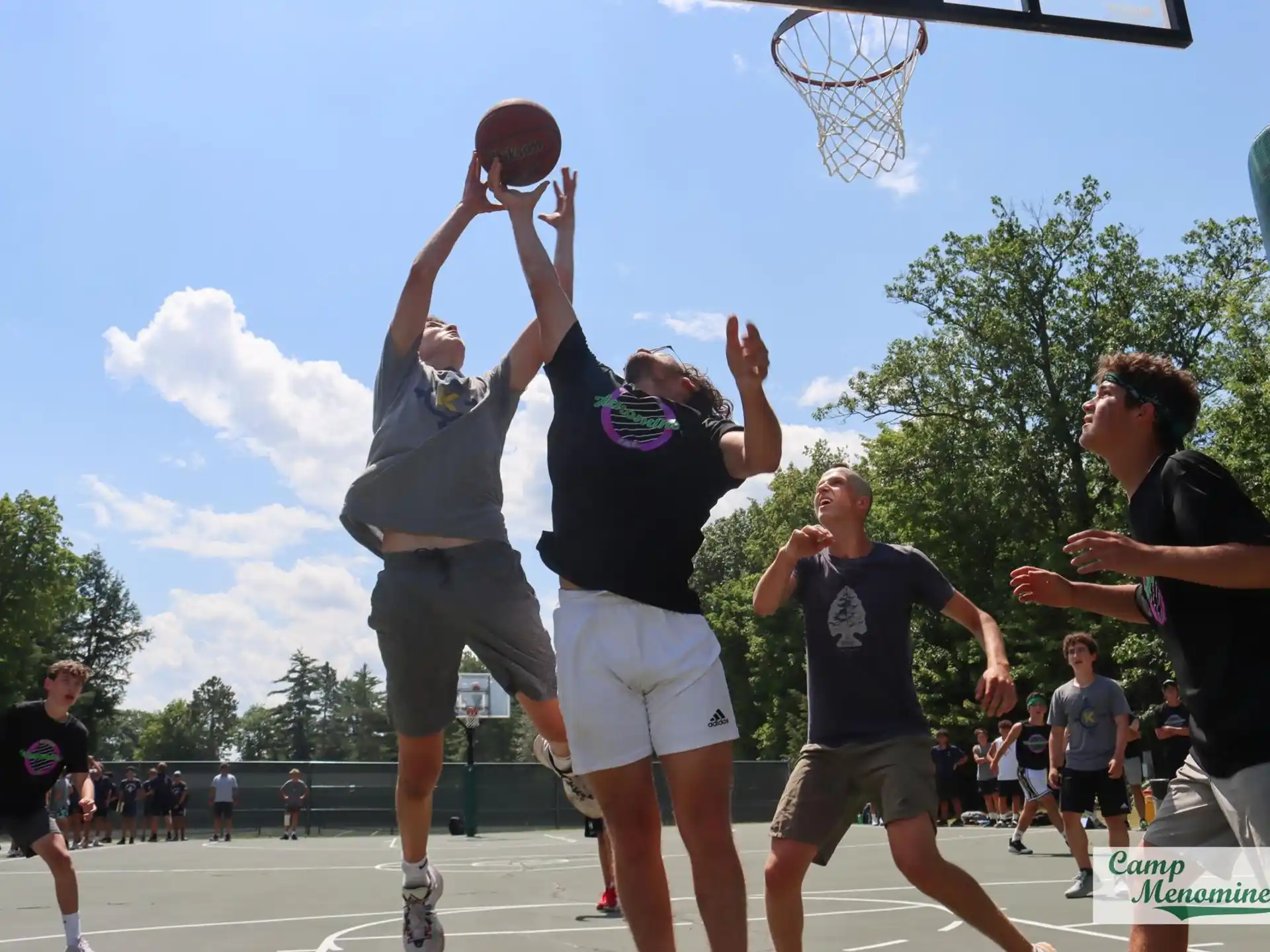 a group of people playing basketball
