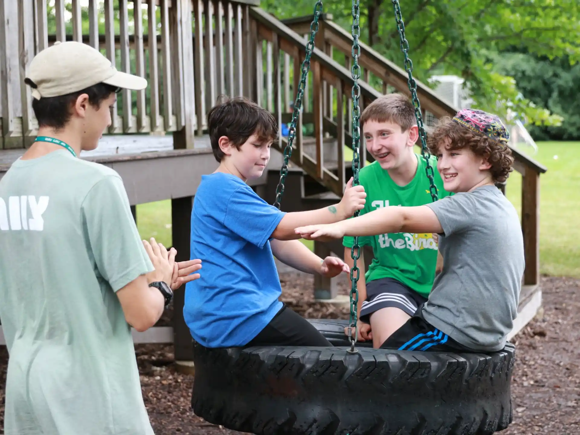 a group of people playing on a swing set