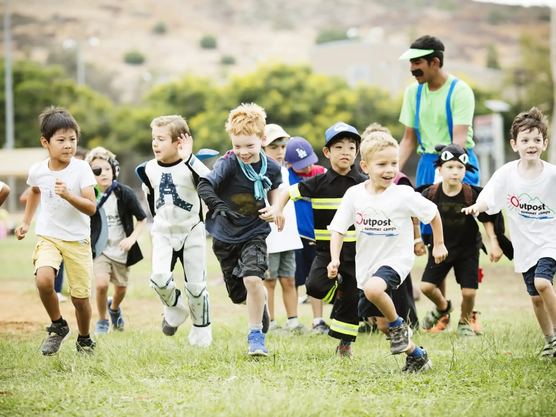 a group of kids running on a field
