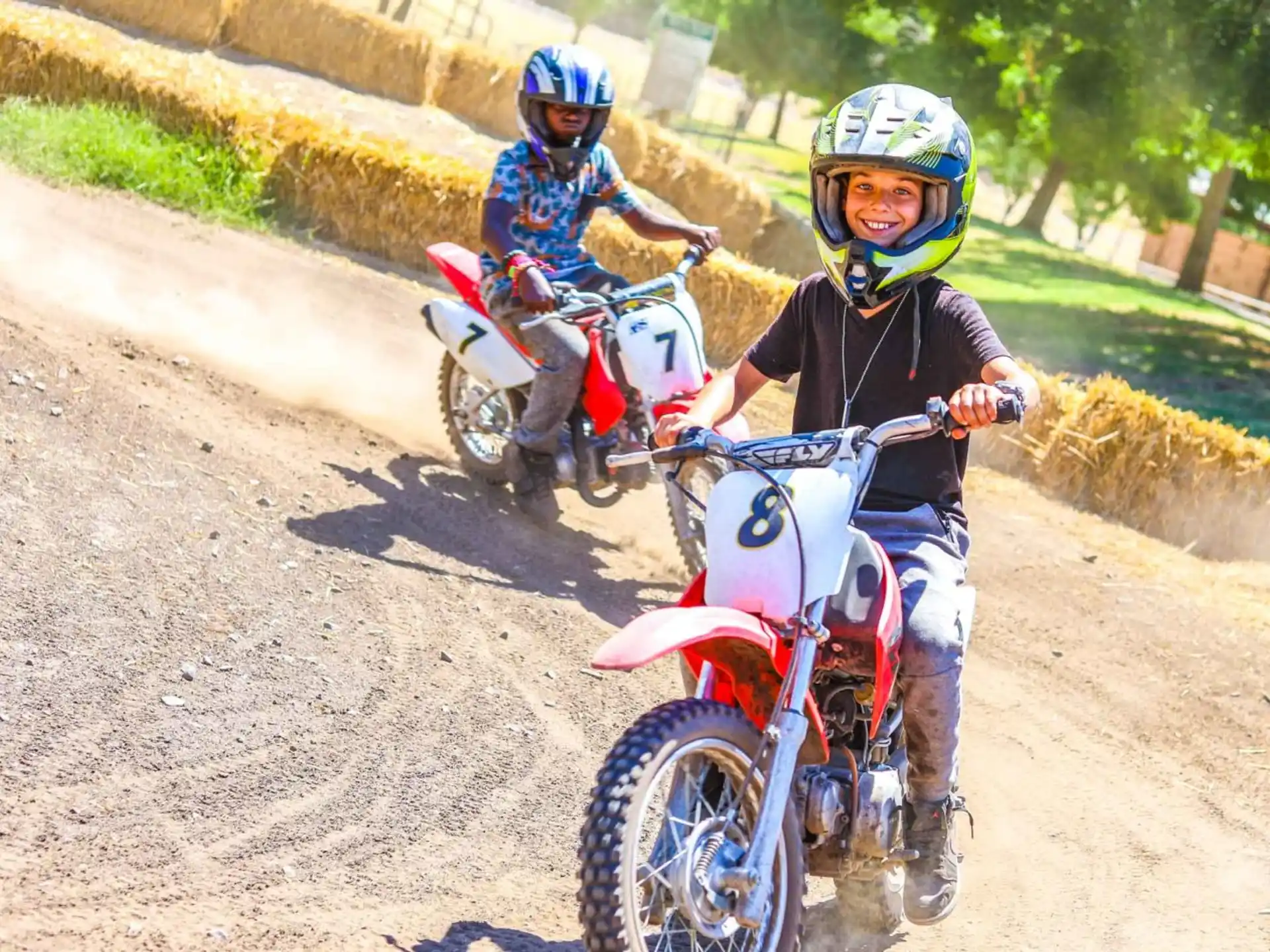 two kids riding motorcycles
