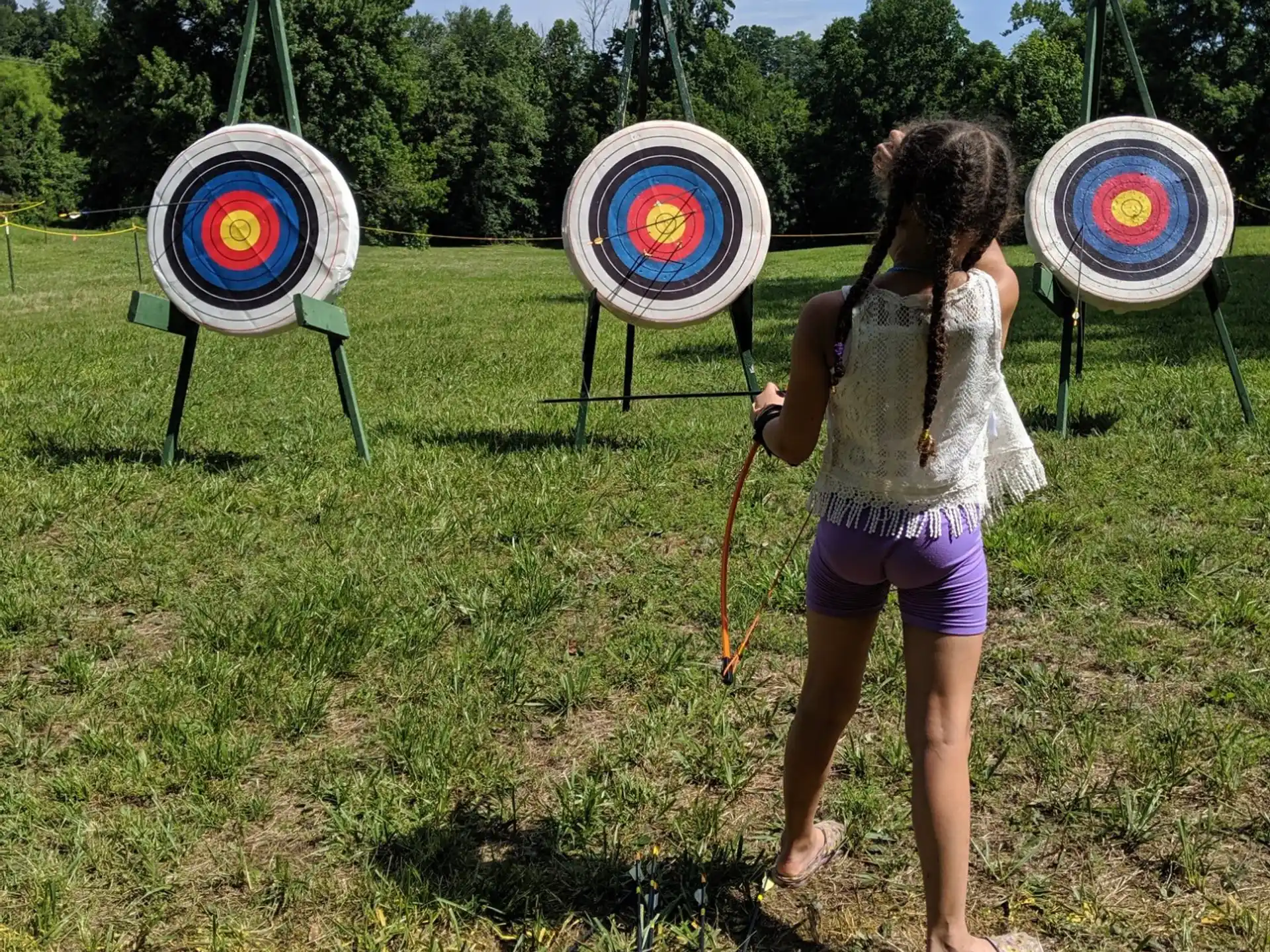 a girl holding a bow and arrow