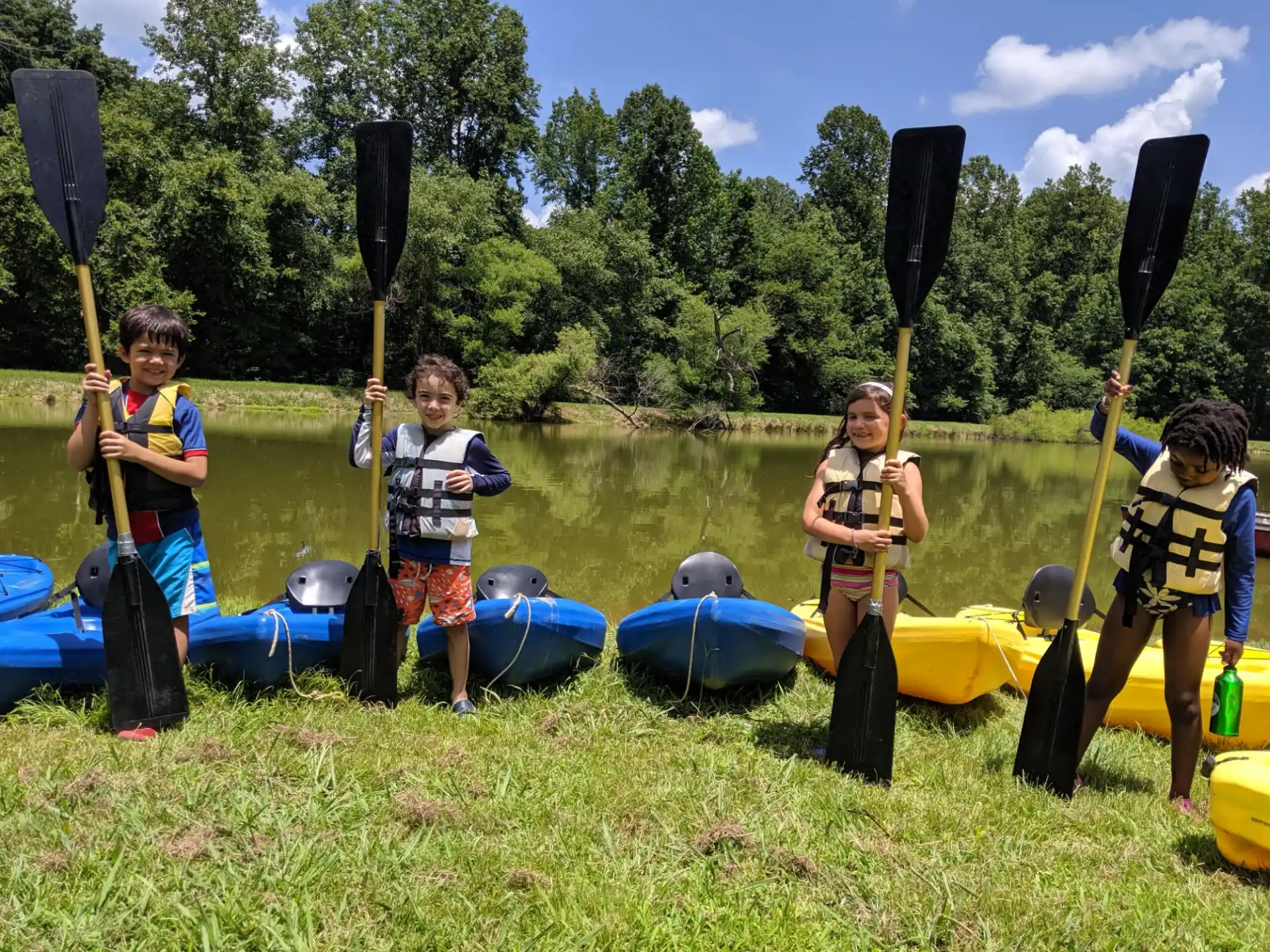 a group of kids holding paddles