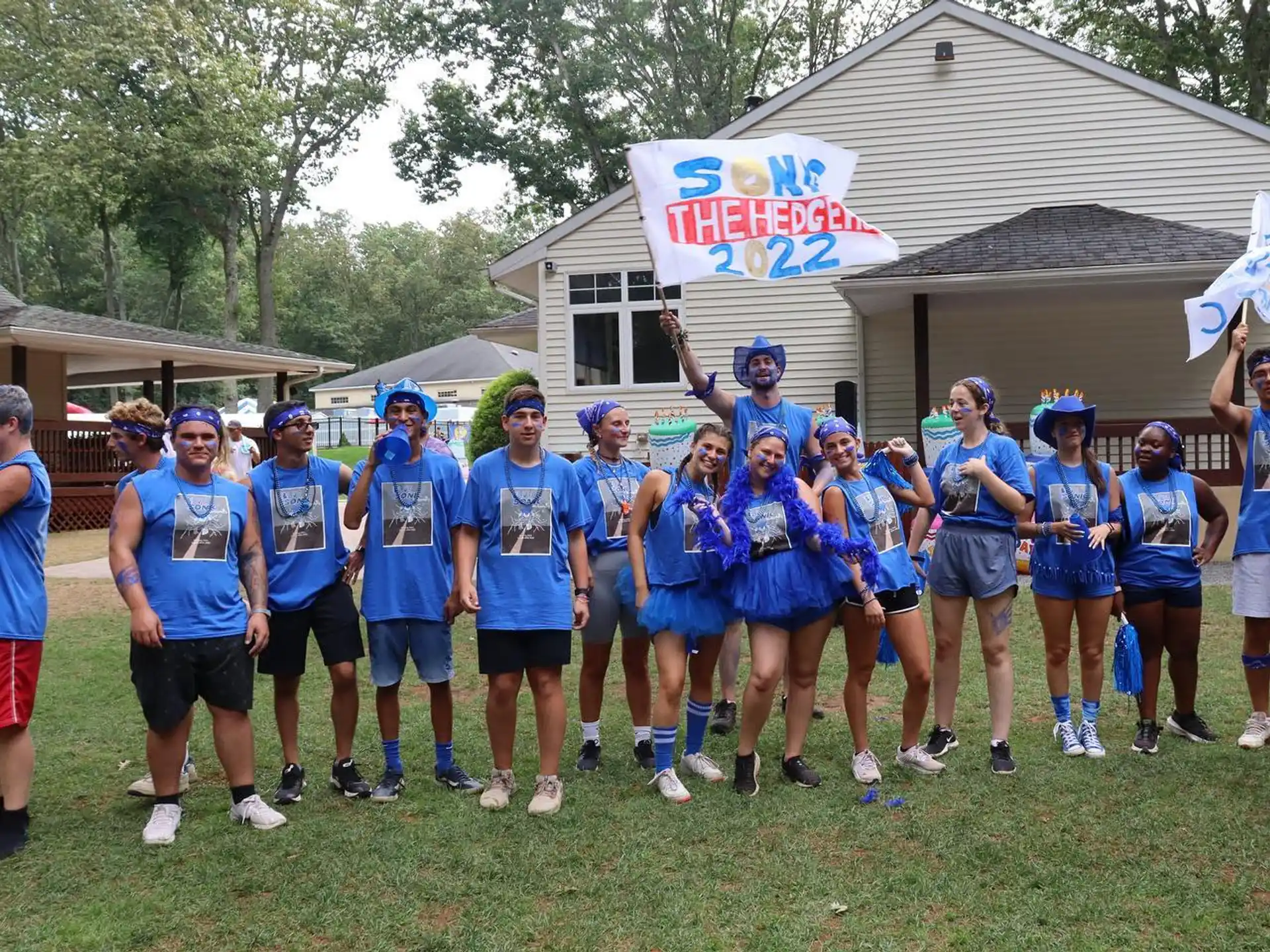a group of people wearing blue shirts and holding signs