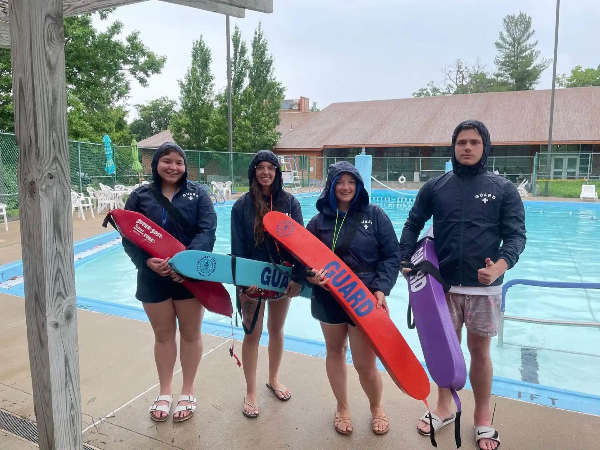 a group of women holding surfboards